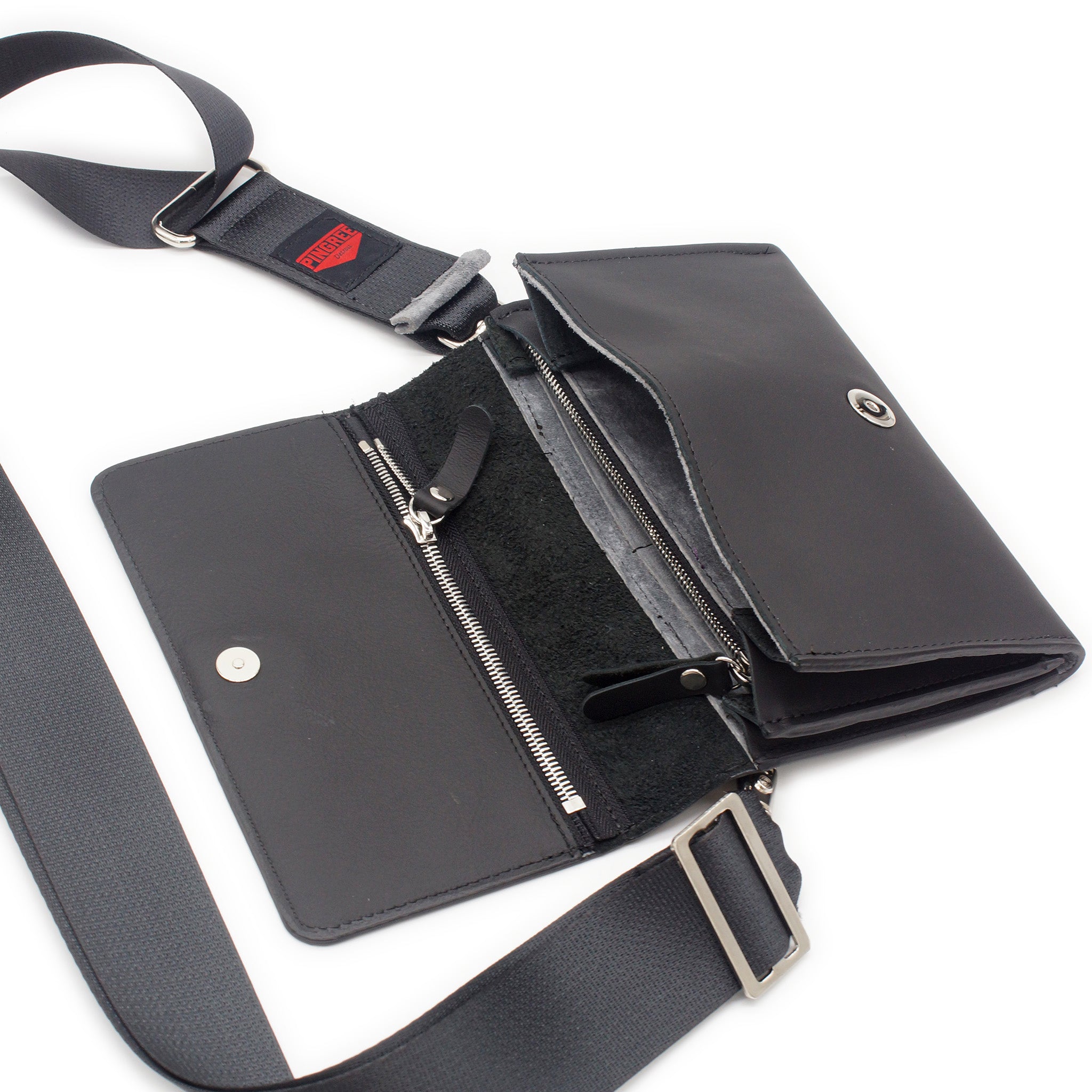 The Adeline Lux, pictured here open with seatbelt straps, a grey interior, and exterior all black leather, upcycled from the automotive industry, with clean rounded corners, magnetic closure, and a wristlet. This 5-in-1 bag is handmade in Detroit, MI USA, with upcycled leather from the automotive industry. Each comes with a picture of the Veteran or Detroiter who made it.
