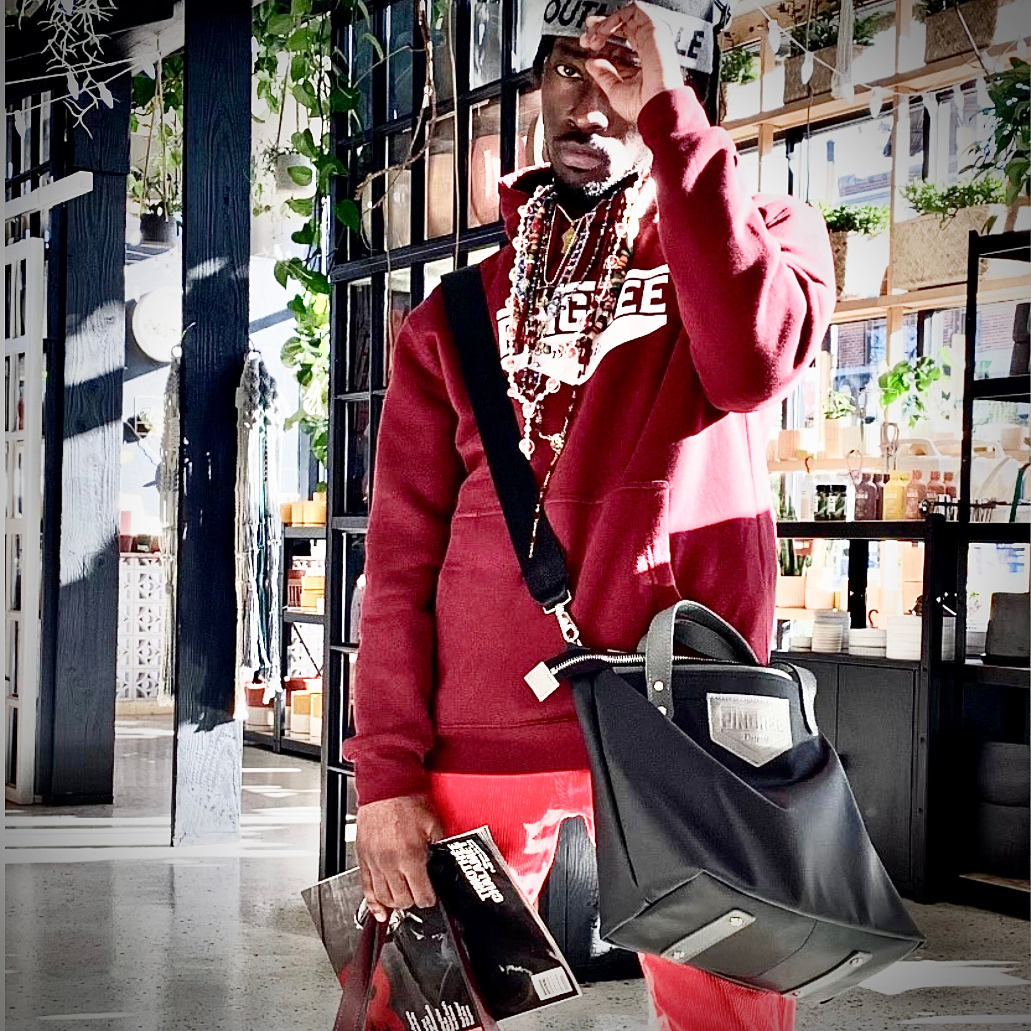 M1 Leather Work & Travel zipper Tote in black in use. Handmade in Detroit with leather up cycled from the Automotive industry with American Made hardware a zipper closure a detachable Crossbody strap included feet on the bottom and grateful for work or travel. Carry-on compliant.