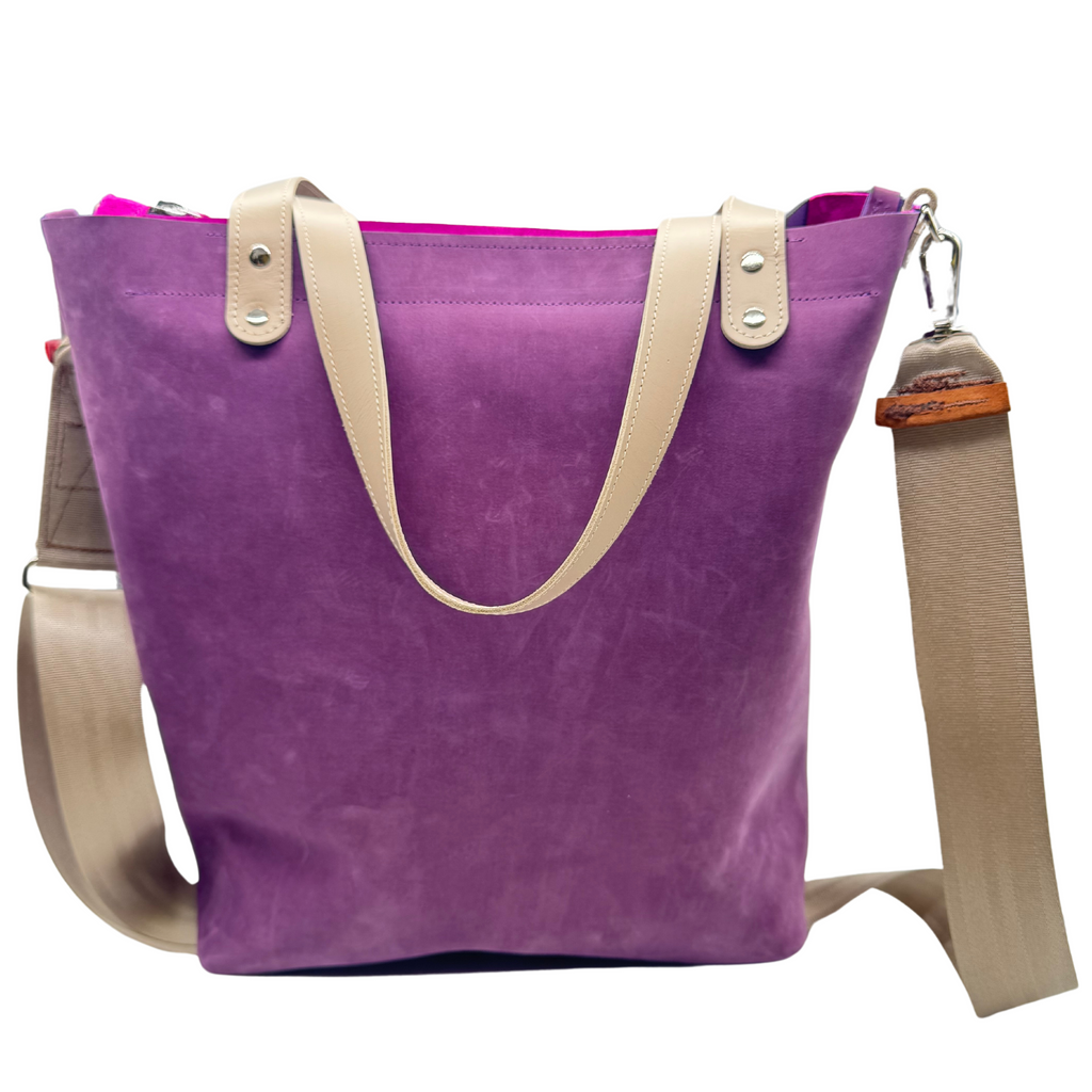 Purple leather bag and travel tote or work bag with a zipper and made sustainably by Pingree Detroit,
In Detroit, with upcycled leather, pictured here with the seat belt crossbody strap