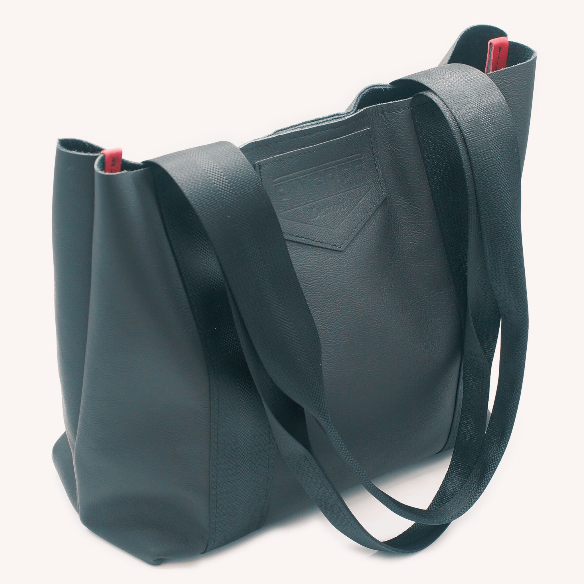 Detroit made leather bag with seatbelt handles, handmade in the USA, in Detroit, MI with upcycled leather from the automotive industry and handmade leather bag by Veterans and Detroiters. Pictured here in a black leather.