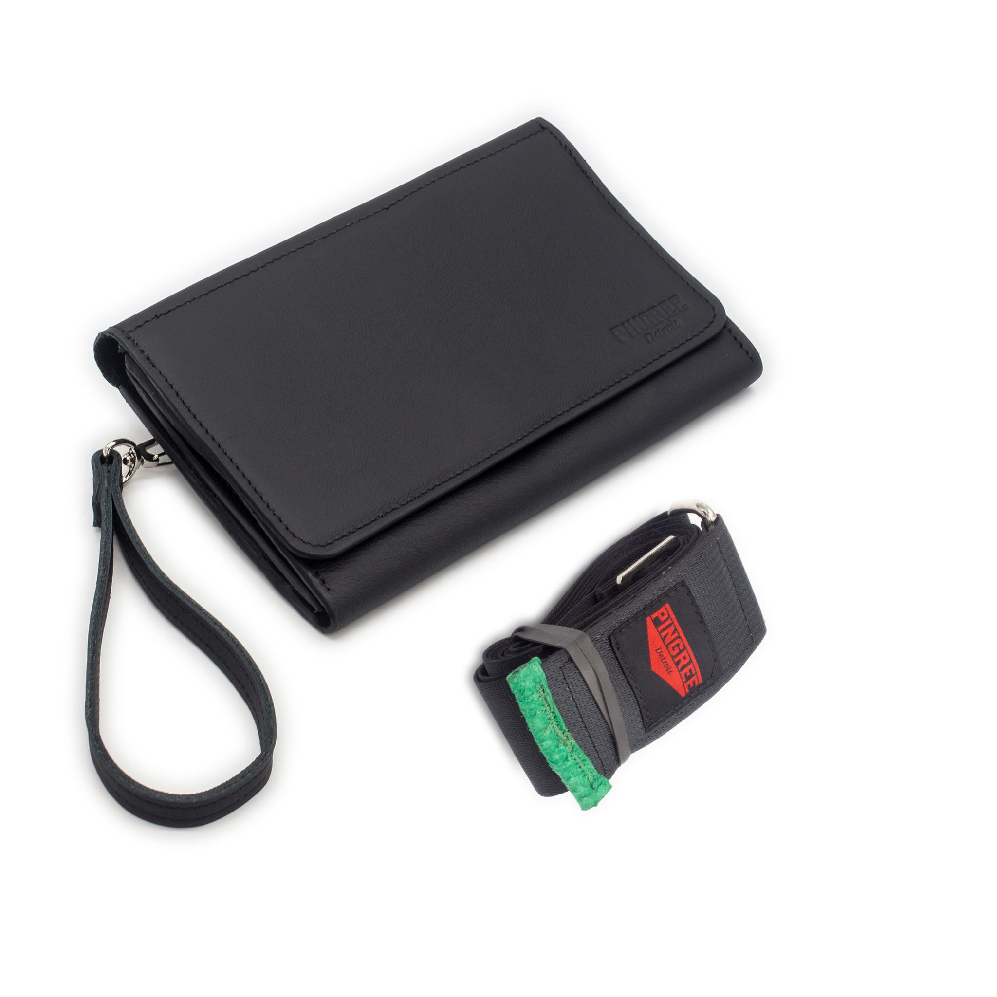 The Adeline Lux, pictured here from the top with seatbelt straps, a Shamrock green suede interior, and exterior all black leather, upcycled from the automotive industry, with clean rounded corners, magnetic closure, and a wristlet. This 5-in-1 bag is handmade in Detroit, MI USA, with upcycled leather from the automotive industry. Each comes with a picture of the Veteran or Detroiter who made it.