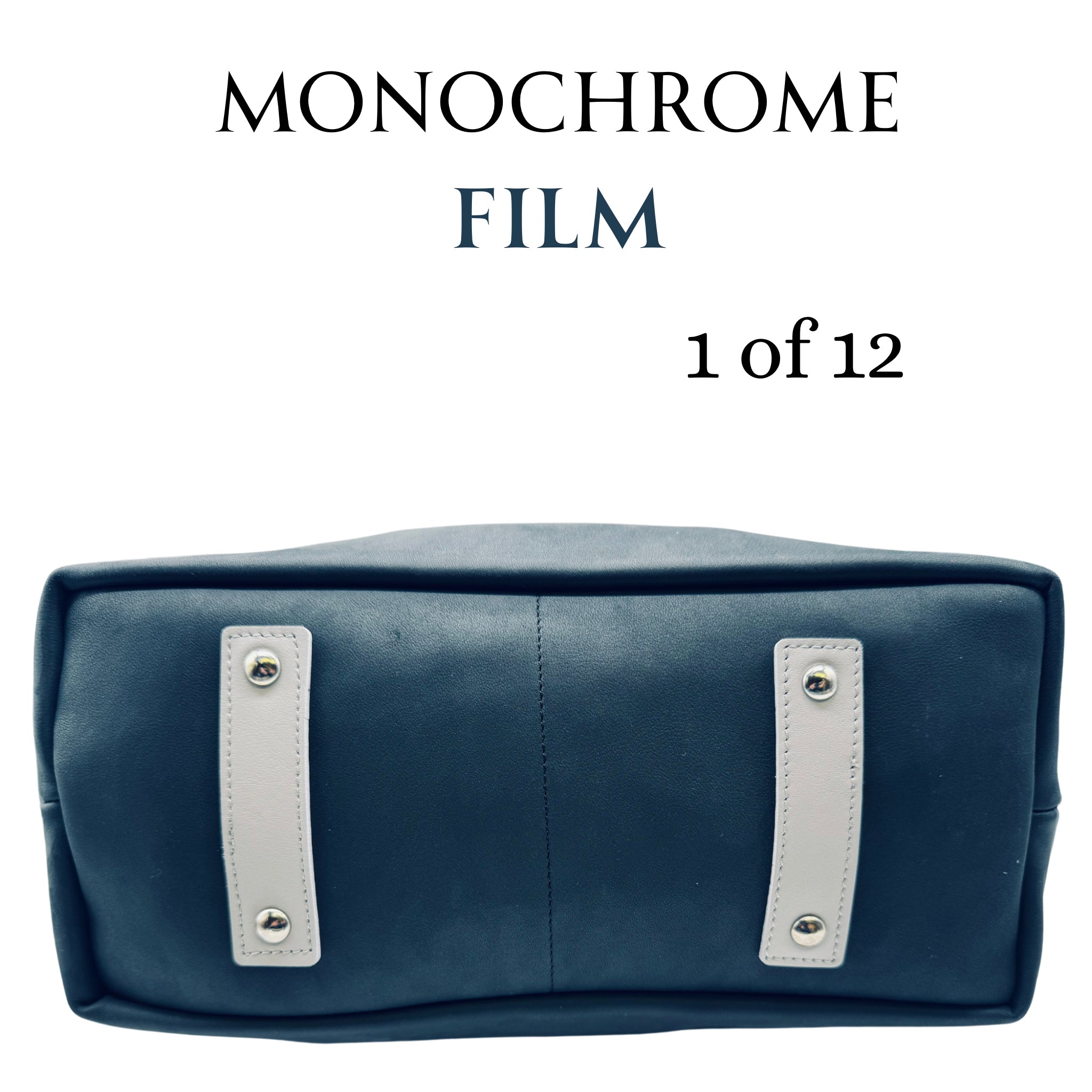 Close-Up of Stitching or Leather Grain:
Close-up on the bottom of the tote feet, focused on the premium upcycled leather and stitching detail on the M1 Travel Tote, designed and handcrafted in Detroit for lasting quality.
