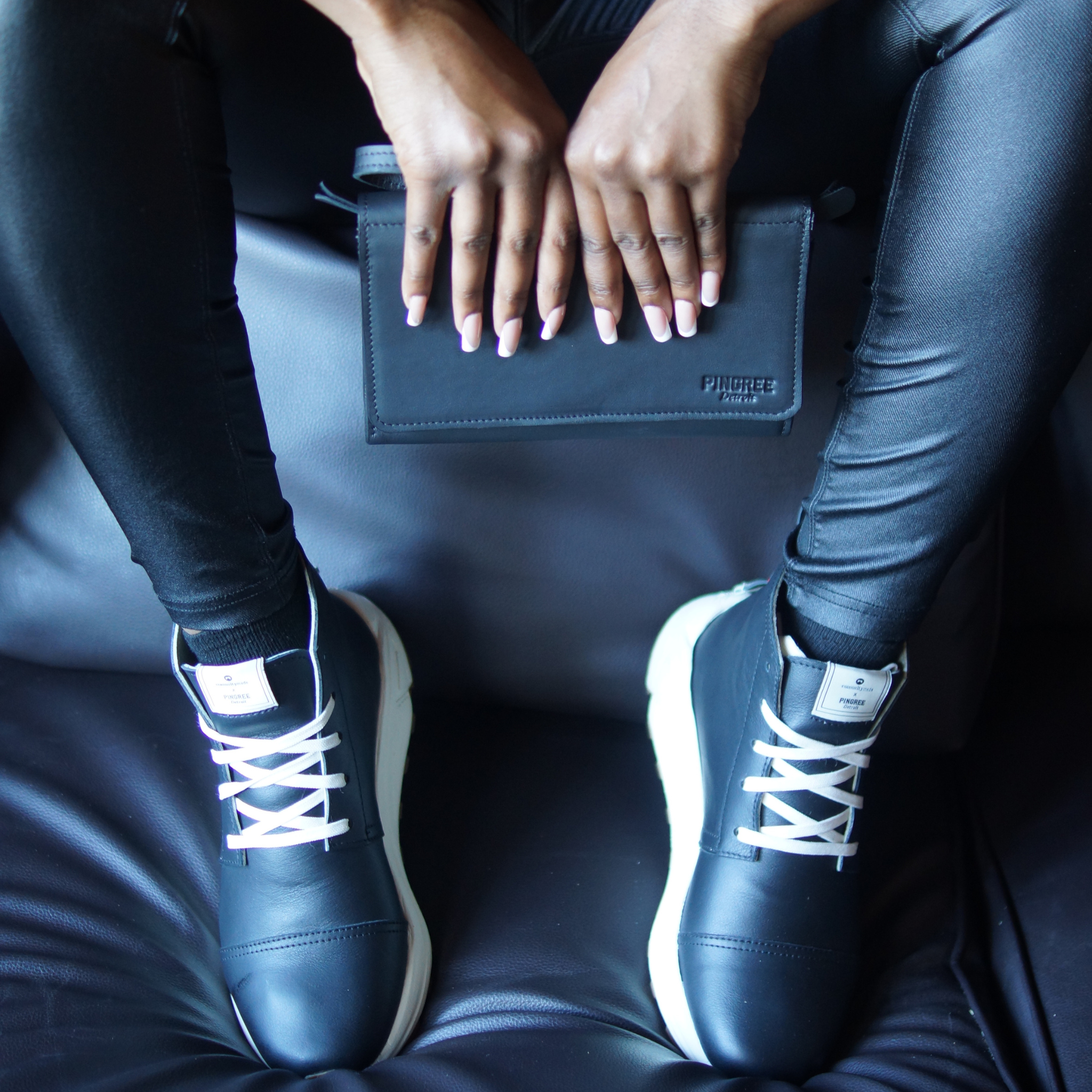 Picured in Onyx with off-white outsole. With a detroit made, american made, leather clutch and crossbody called the Adeline Lux, in front of our Chukka Boot, Designed and handmade collaboratively in the USA alongside @comunitymade with upcycled leather and our new Vibram ecostep sole made from recycled materials. This boot’s got the perfect mix of style, comfort, durability, and a lighter footprint on the planet.