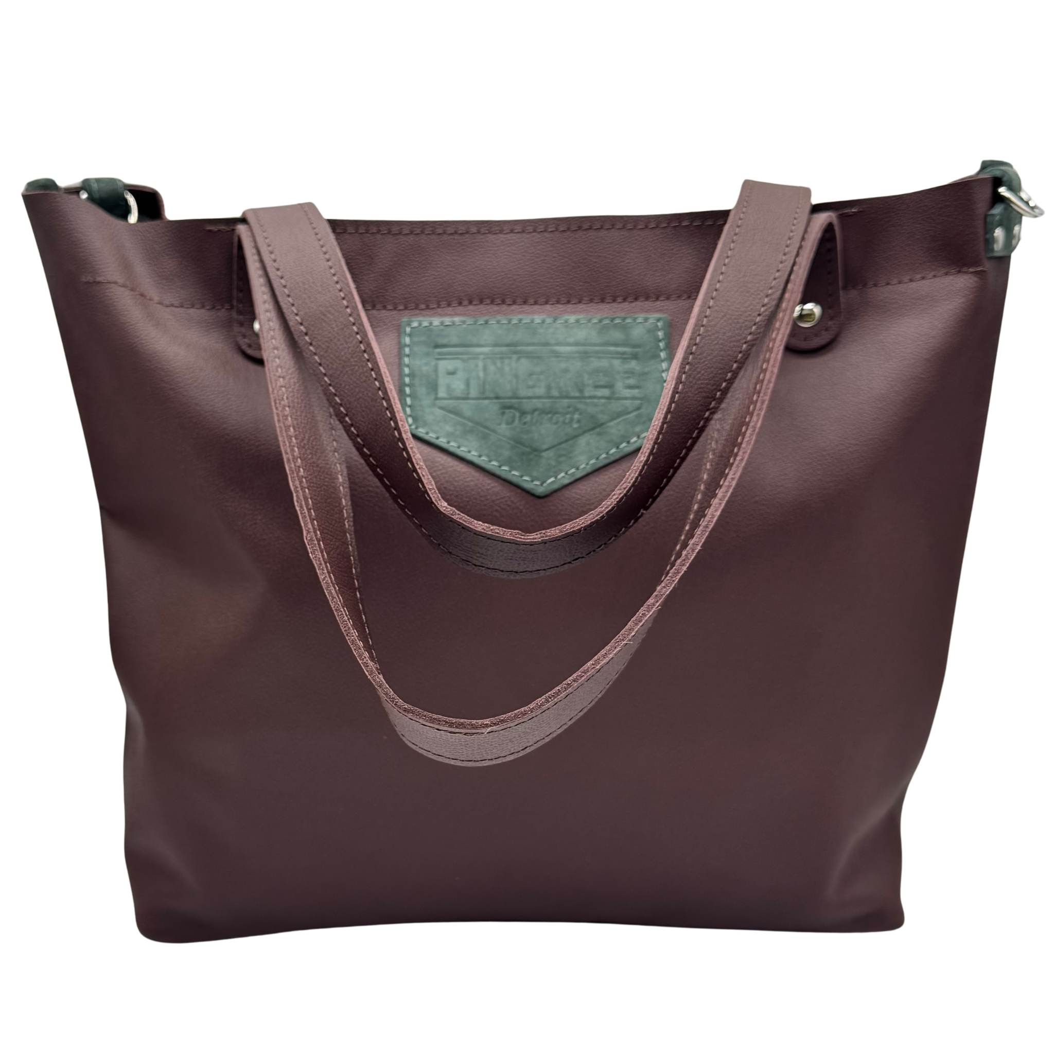 M1 Leather Work & Travel zipper Tote in mahogany called “ hearth and sage”. Handmade in Detroit with leather up cycled from the Automotive industry with American Made hardware a zipper closure a detachable Crossbody strap included feet on the bottom and grateful for work or travel. Carry-on compliant.