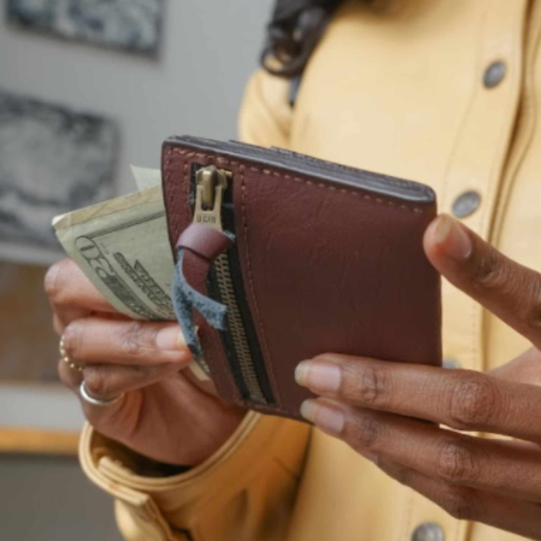 A simple, minimalist, durable, leather wallet that holds up to 8 credit cards and includes a rear zipper. Cash fits perfectly folded once in the top slot. All materials are upcycled from the automotive industry or American-made.