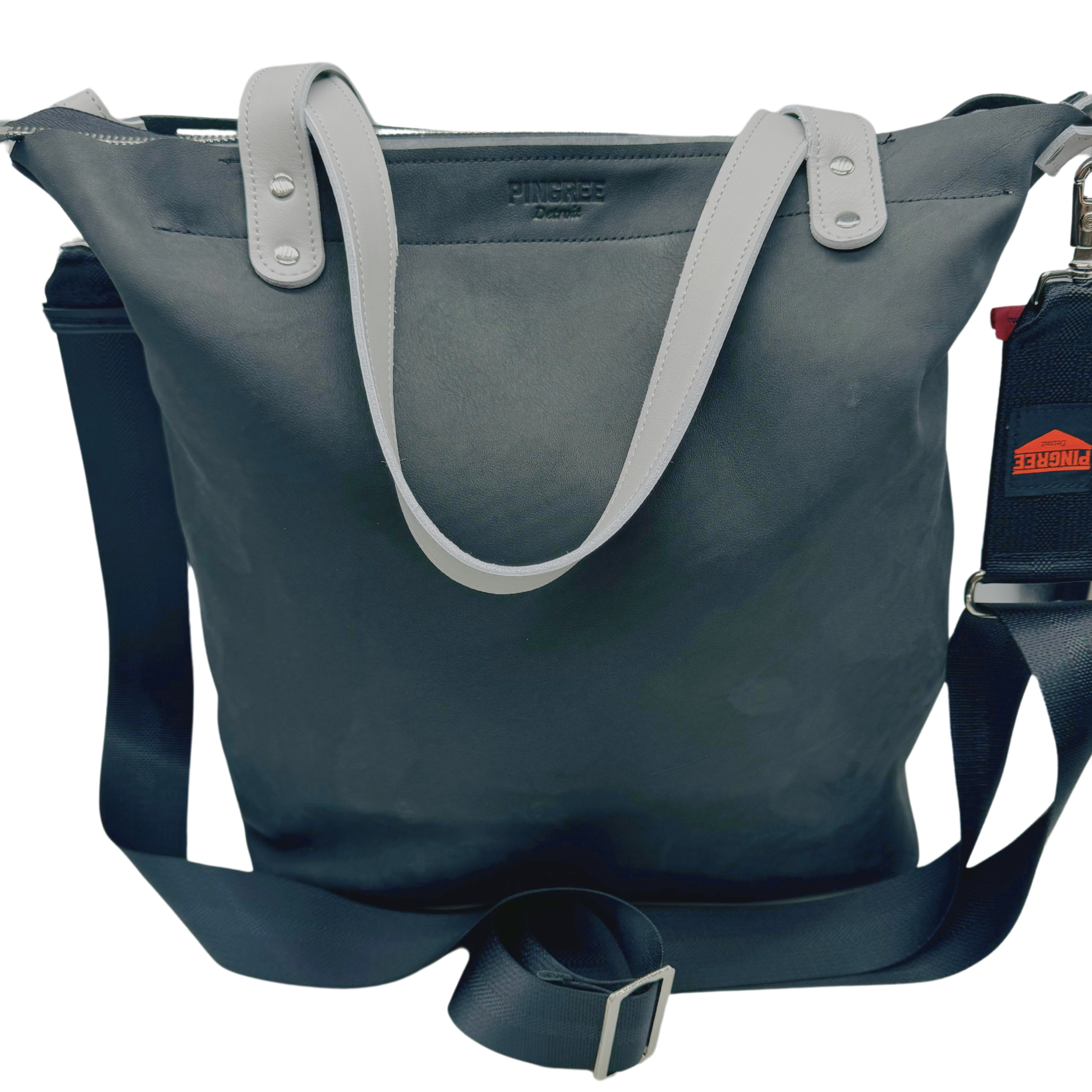 📸 Product on White Background:
Front shot of our onyx black leather carryon in a tote. M1 Travel Tote made in Detroit from upcycled automotive leather, shown with detachable crossbody strap – sustainable, durable travel bag for everyday use.”