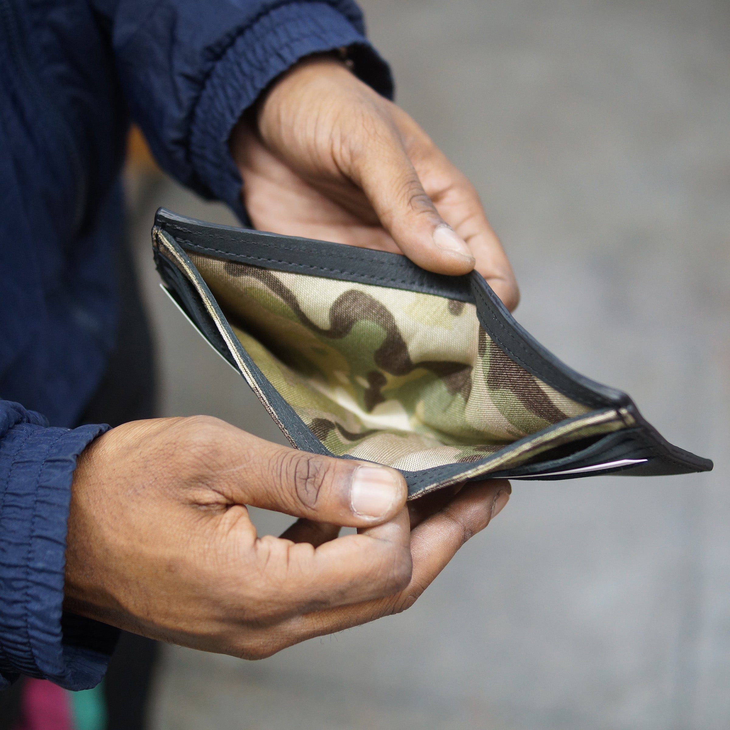 Onyx black billfold wallet, pictured here open. Made in Detroit, Michigan USA. Big enough for George Costanza, 10 pockets, leather upcycled from the production of new cars, handmade in Detroit by U.S. Veterans and Detroiters. Liner made from upcycled material from the production of Army tents.