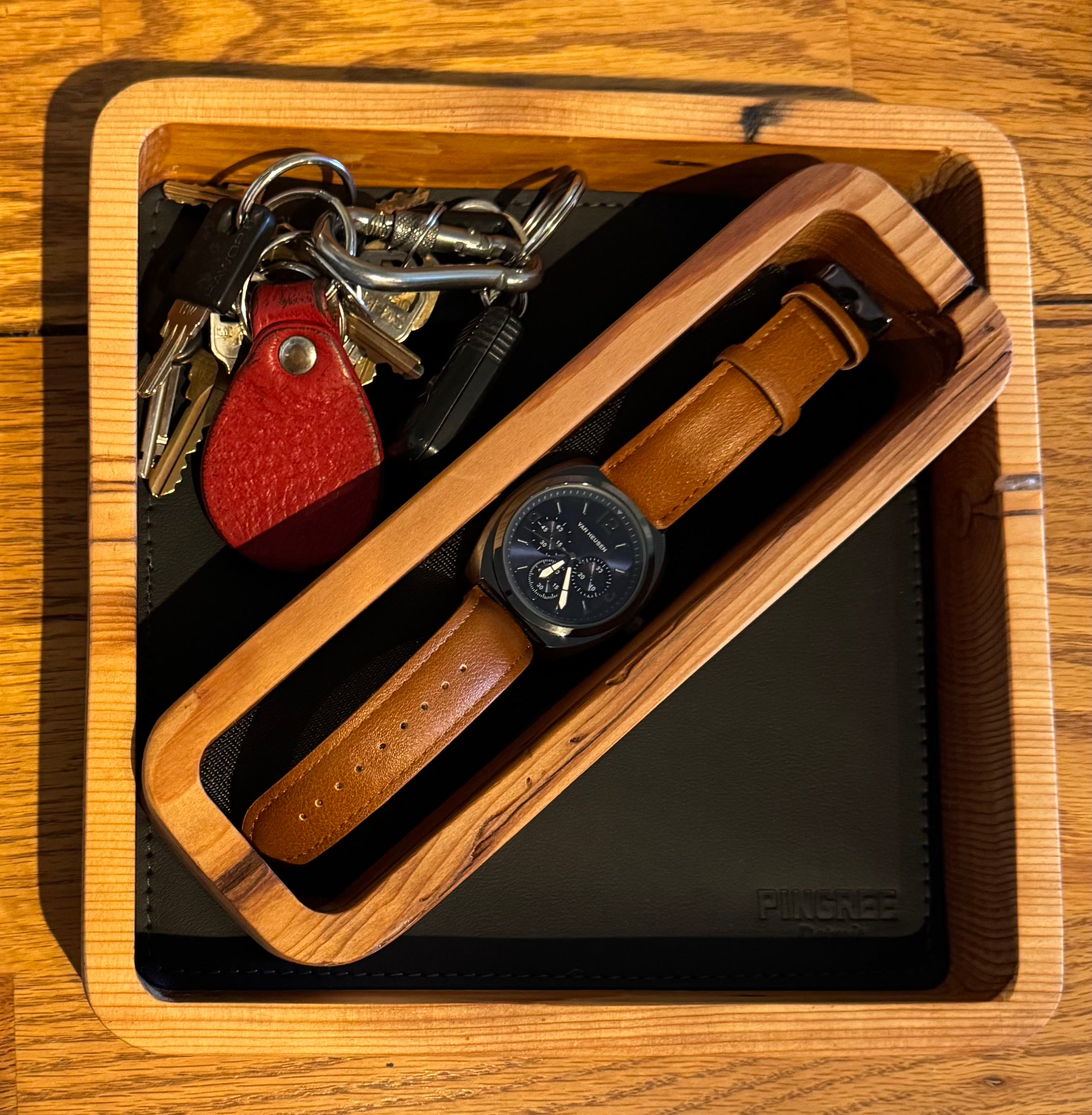 Rustic modern valet tray handcrafted from reclaimed Detroit wood and car leather, designed to organize essentials like keys, phones, and jewelry in your home entryway or dresser.