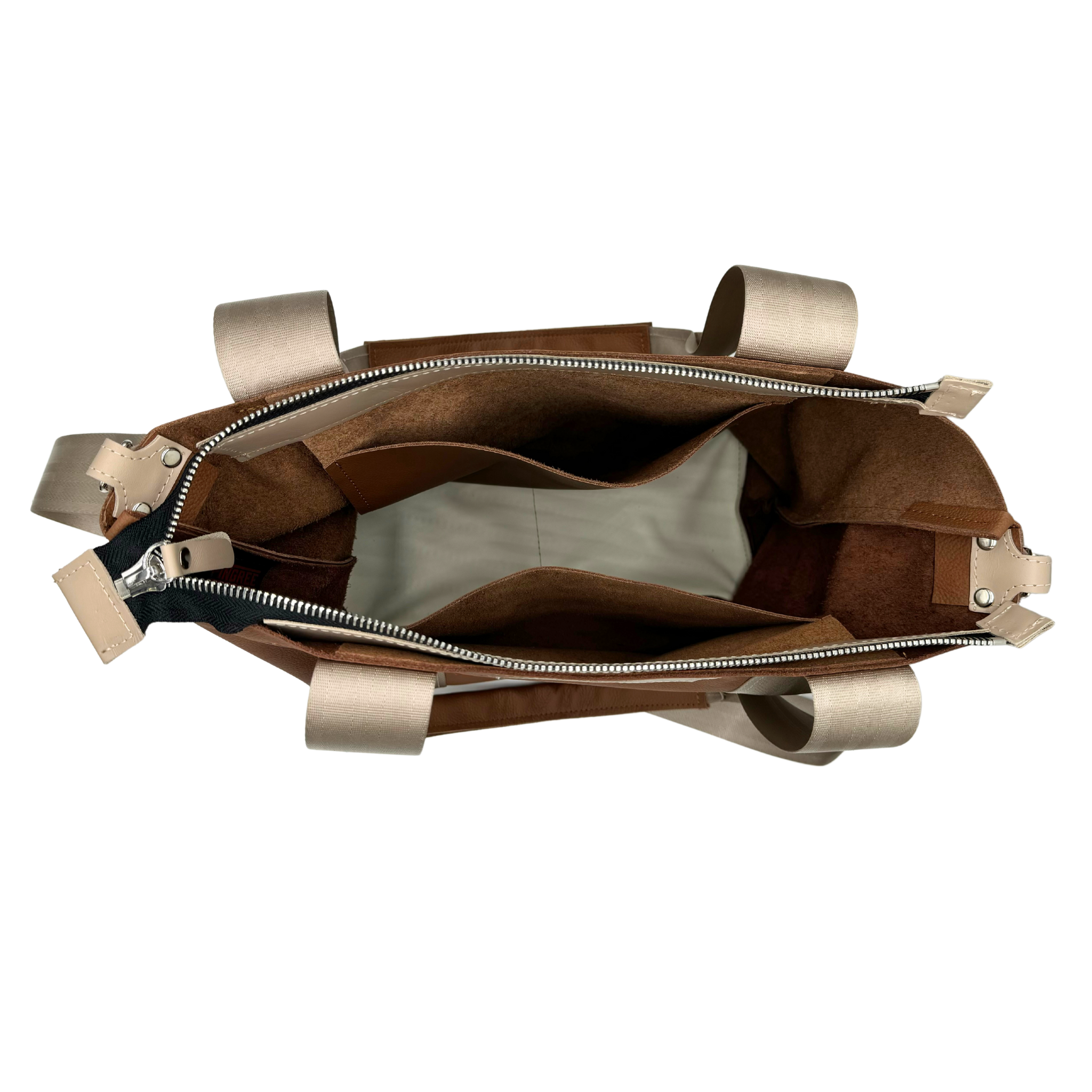 M1 Leather Work & Travel zipper Tote inside view. Handmade in Detroit with leather up cycled from the Automotive industry with American Made hardware a zipper closure a detachable Crossbody strap included feet on the bottom and grateful for work or travel. Carry-on compliant.