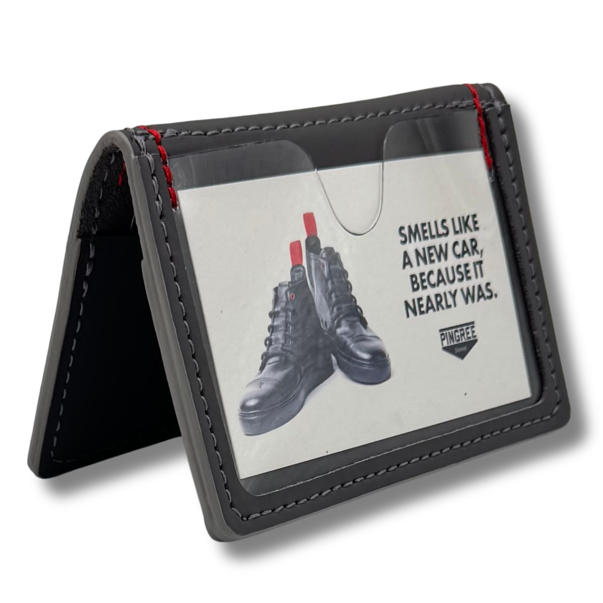 Pictured here in a dark gray with the idea, window facing forward. A five pocket minimalist front pocket wallet made with leather upcycled from the production of new cars, wallet is handmade in the USA, made in America, made in Detroit, with a ID window and five cars slots each holding two cards plus a cash pouch in the middle.