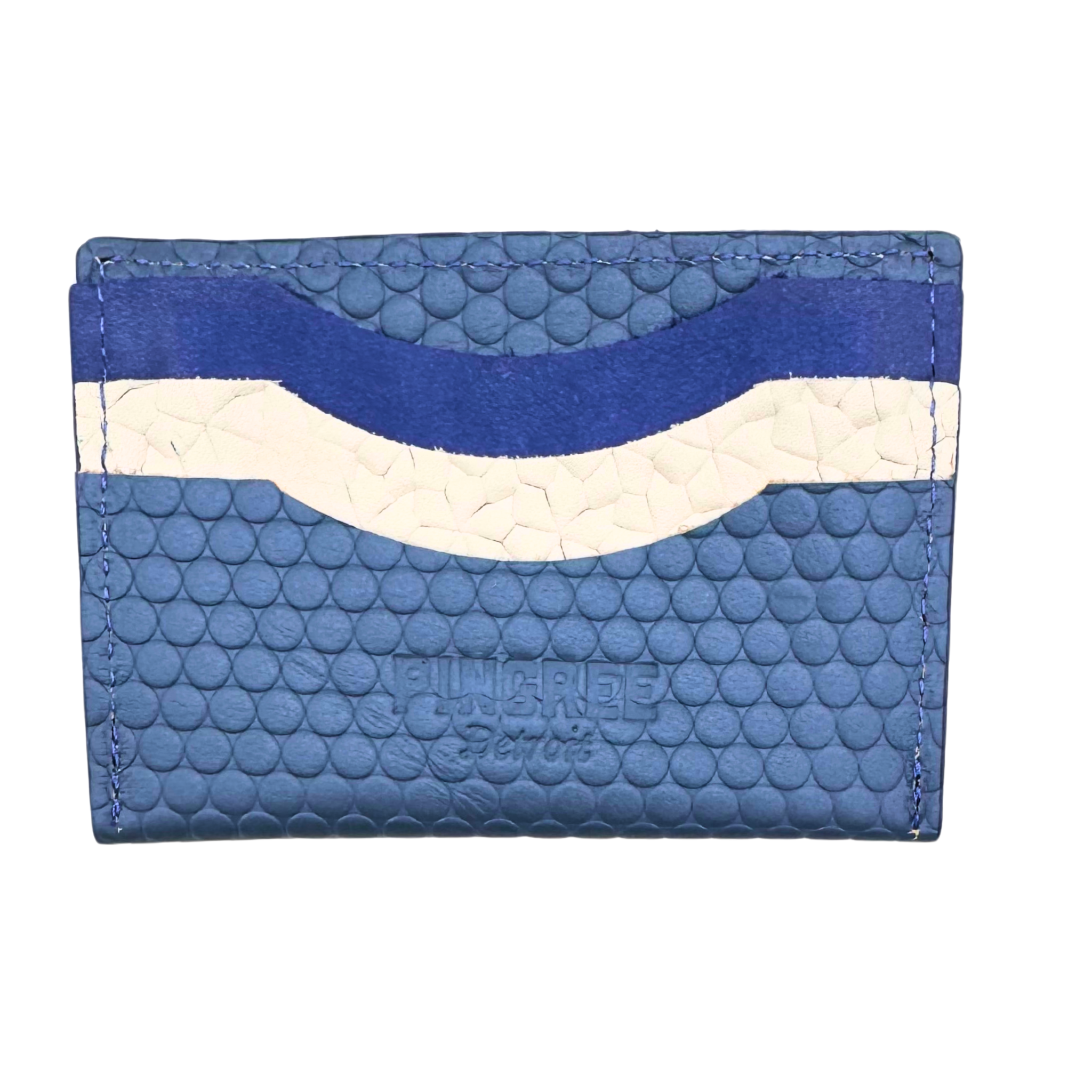 Picture to hear in blue. A simple, minimalist, durable, leather wallet that holds up to 8 credit cards and includes a rear zipper. Cash fits perfectly folded once in the top slot. All materials are upcycled from the automotive industry or American-made.