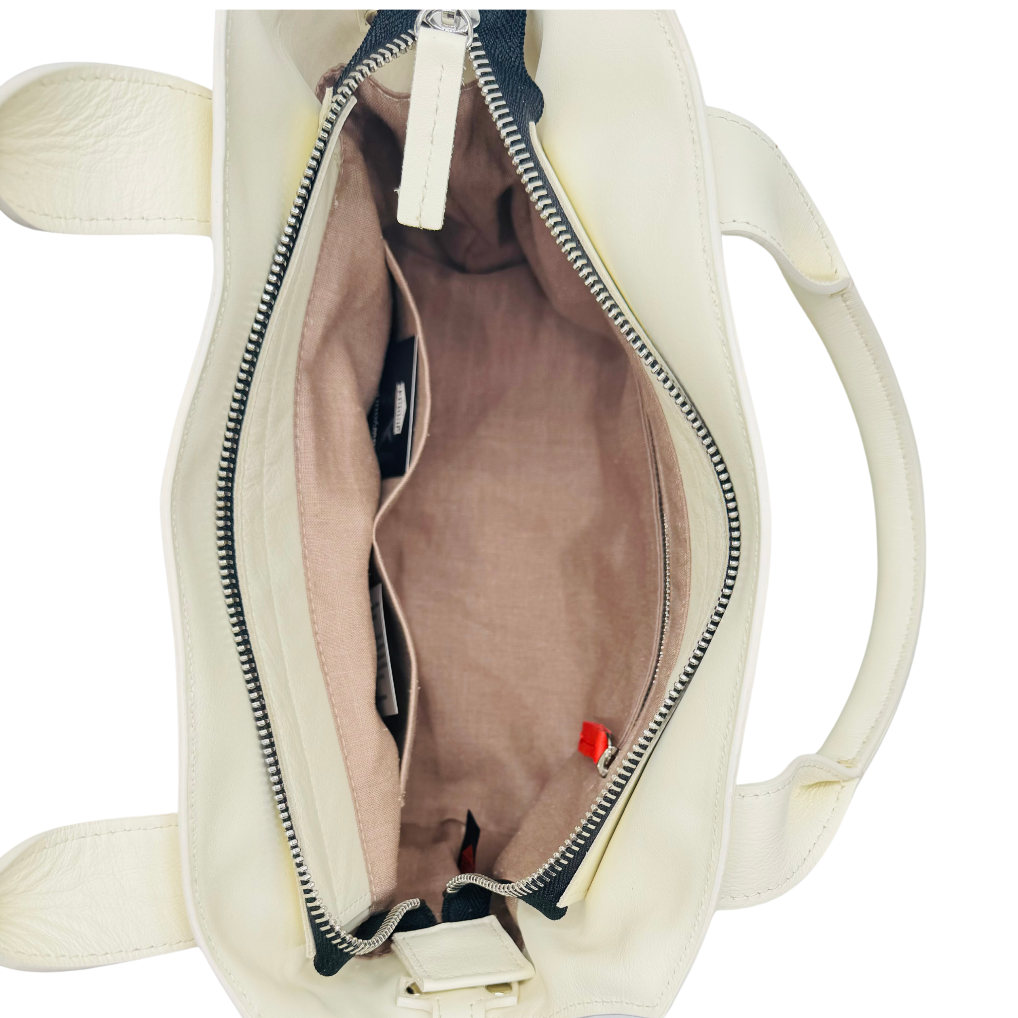 Off white inside of the pingree purse, with interior pockets and zipper pocket. Made in Detroit and leather upcycled from automotive indusrtry.