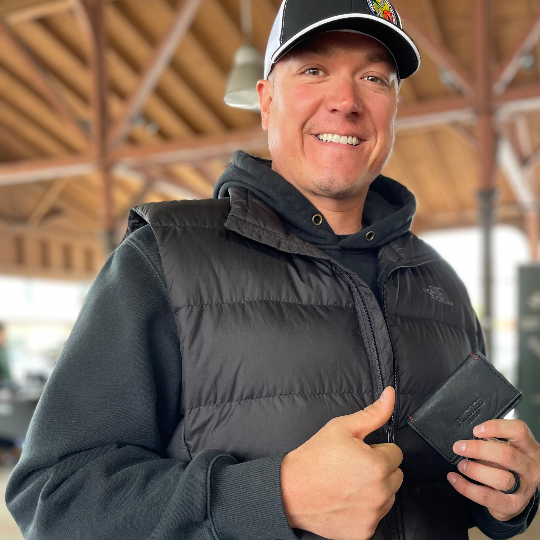 A happy customer pictured here holding the wallet in our Onyx black variety.