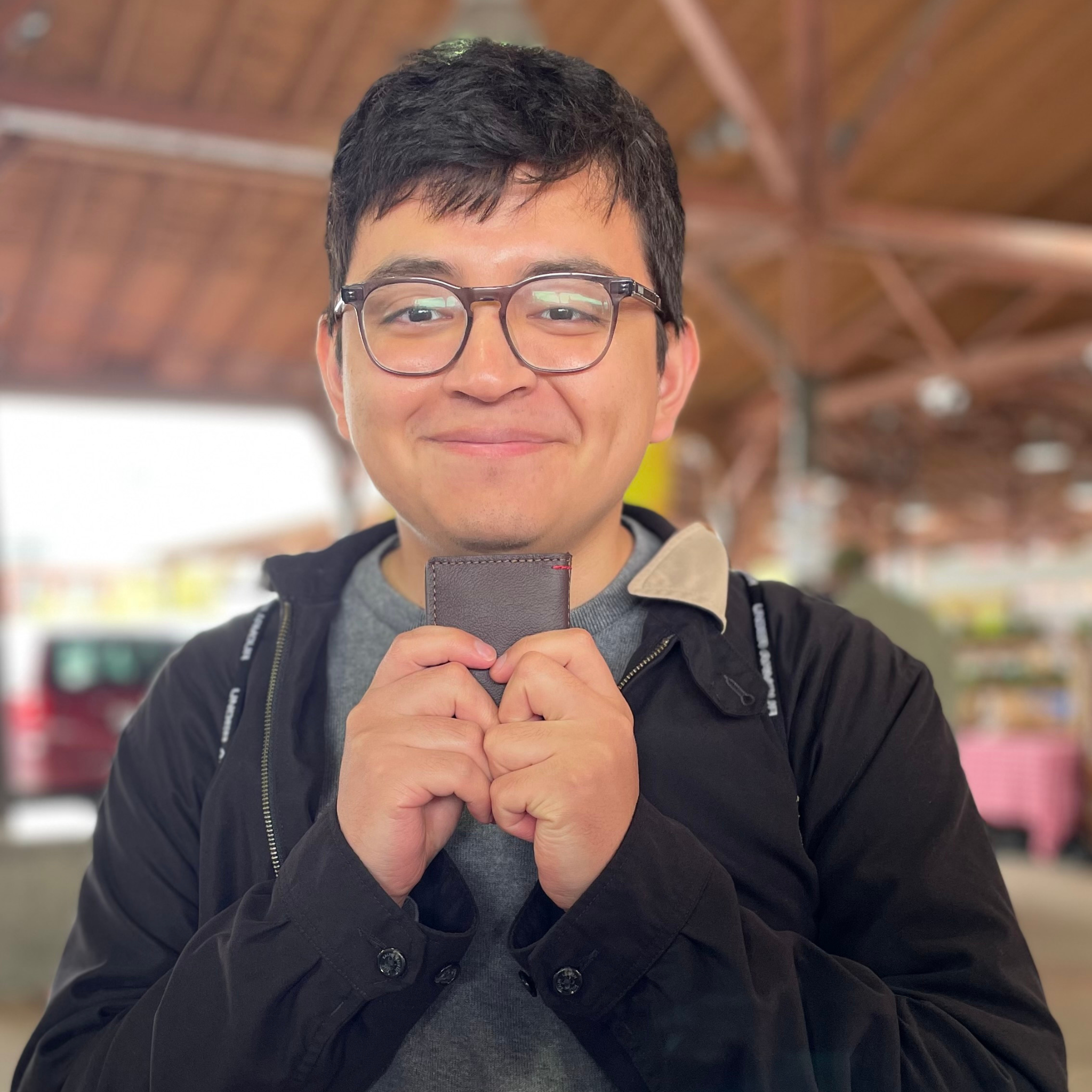 Pictured here is another happy customer holding his wallet. A four pocket minimalist front pocket wallet made with leather upcycled from the production of new cars, wallet is handmade in the USA, made in America, made in Detroit, with four card slots each holding two cards plus a cash pouch in the middle.