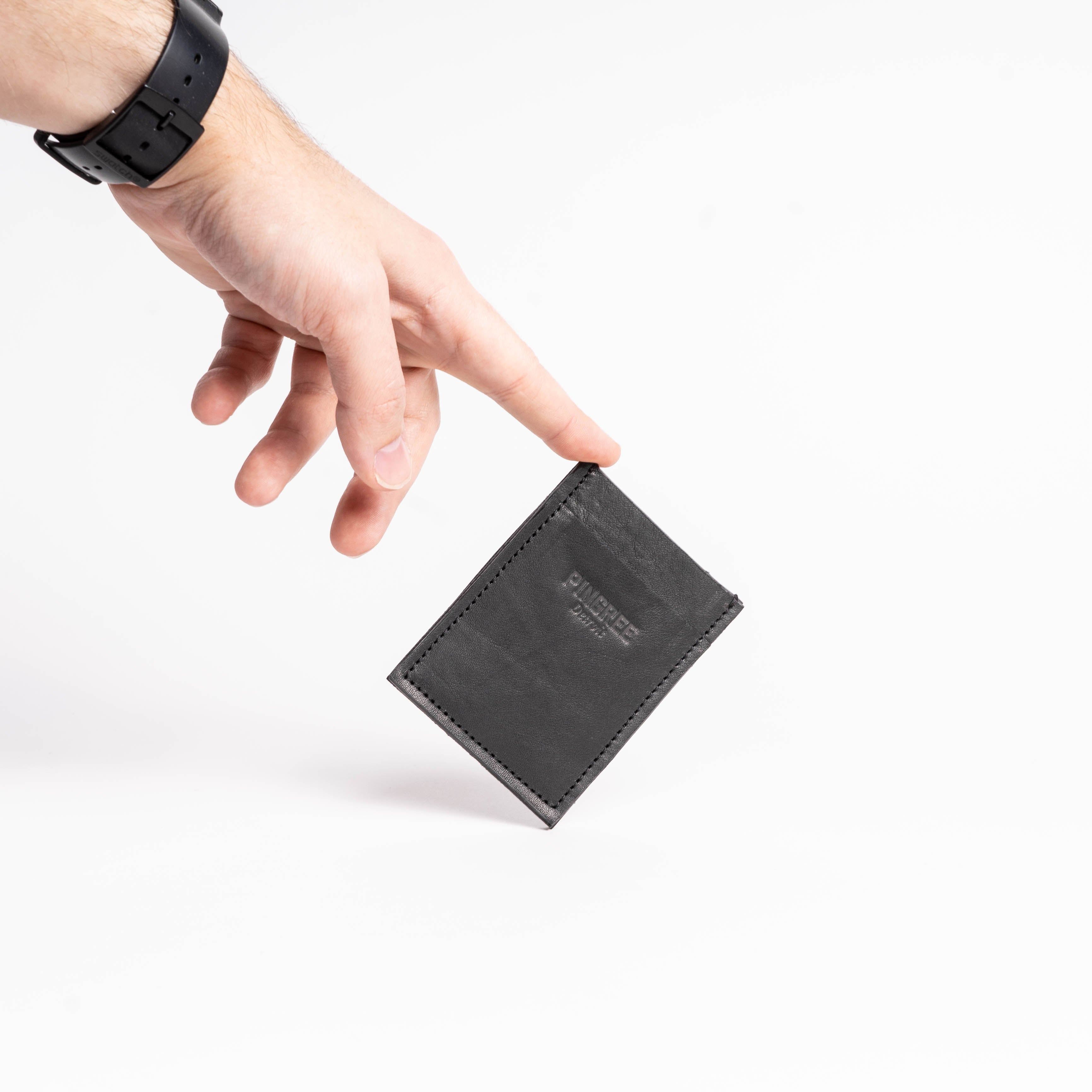 A slim three pocket wallet with a pull tab in the middle pocket to make it easy to pull cards out when the wallet is full of cash and cards. Made with upcycled cards and Leather from the automotive industry. And handcrafted by Veterans and Detroiters in the Motor city.