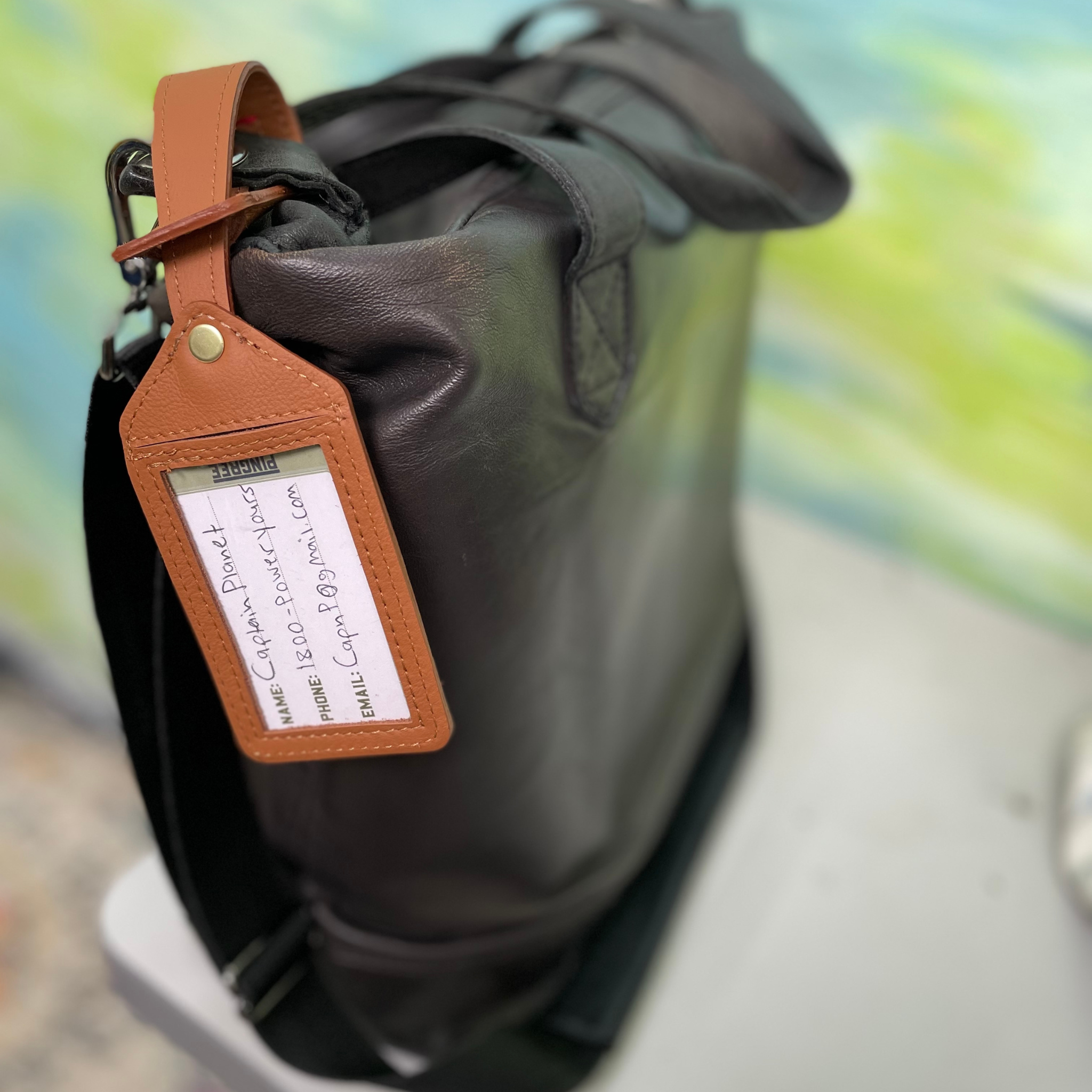 Luggage tag mad in Detroit by hand with upcycled leather from the auto industry . Made in the USA sustainably.