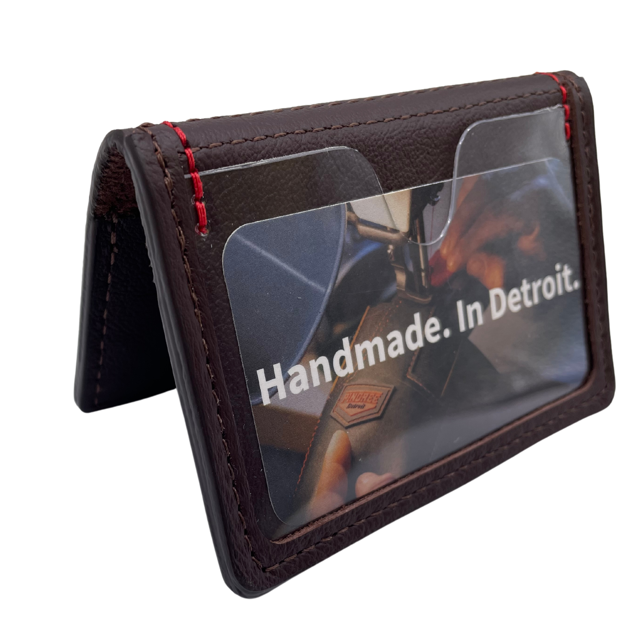 A deep brown in the mahogany color family with five pockets and the ID window facing forward. A five pocket minimalist front pocket wallet made with leather upcycled from the production of new cars, wallet is handmade in the USA, made in America, made in Detroit, with a ID window and five cars slots each holding two cards plus a cash pouch in the middle.
