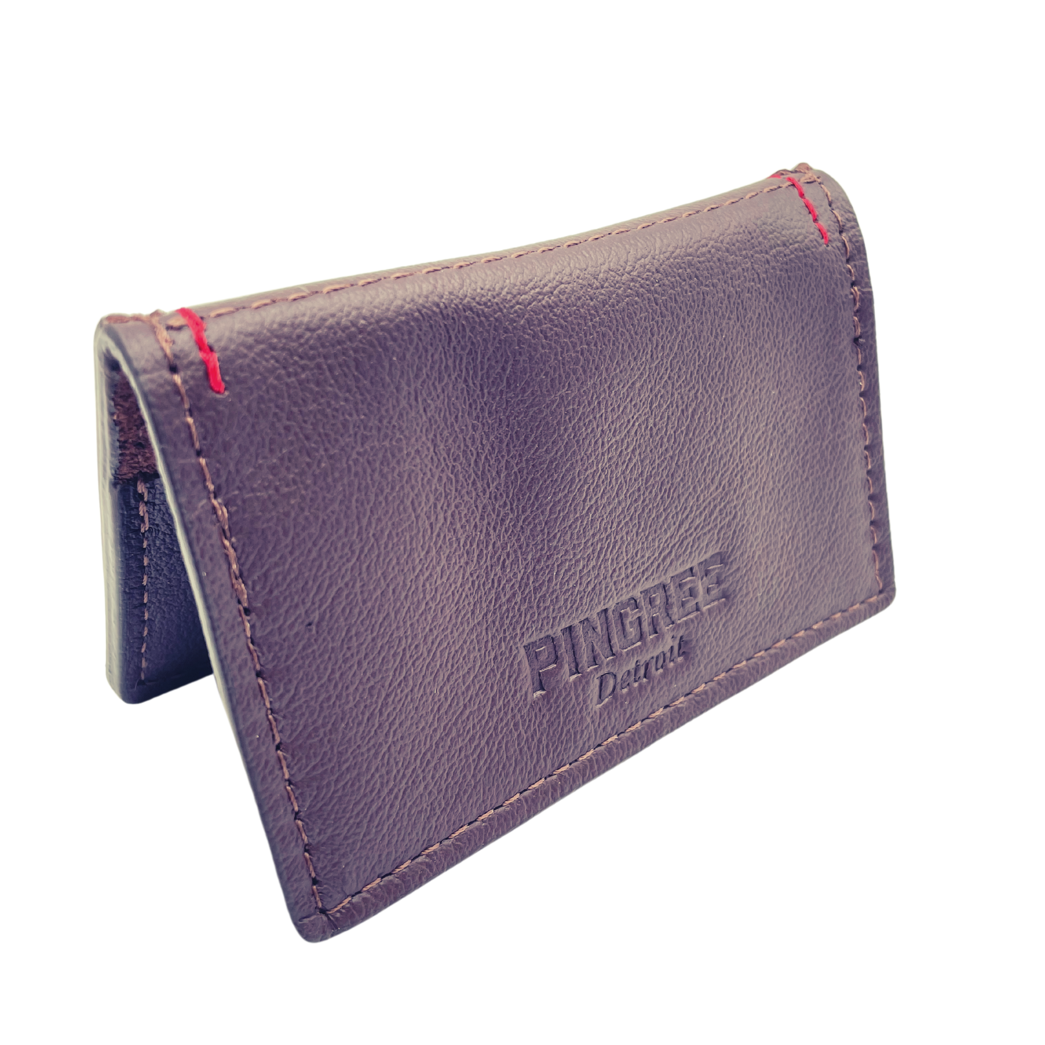 Pictured here in mahogany facing forward. A four pocket minimalist front pocket wallet made with leather upcycled from the production of new cars, wallet is handmade in the USA, made in America, made in Detroit, with four card slots each holding two cards plus a cash pouch in the middle.