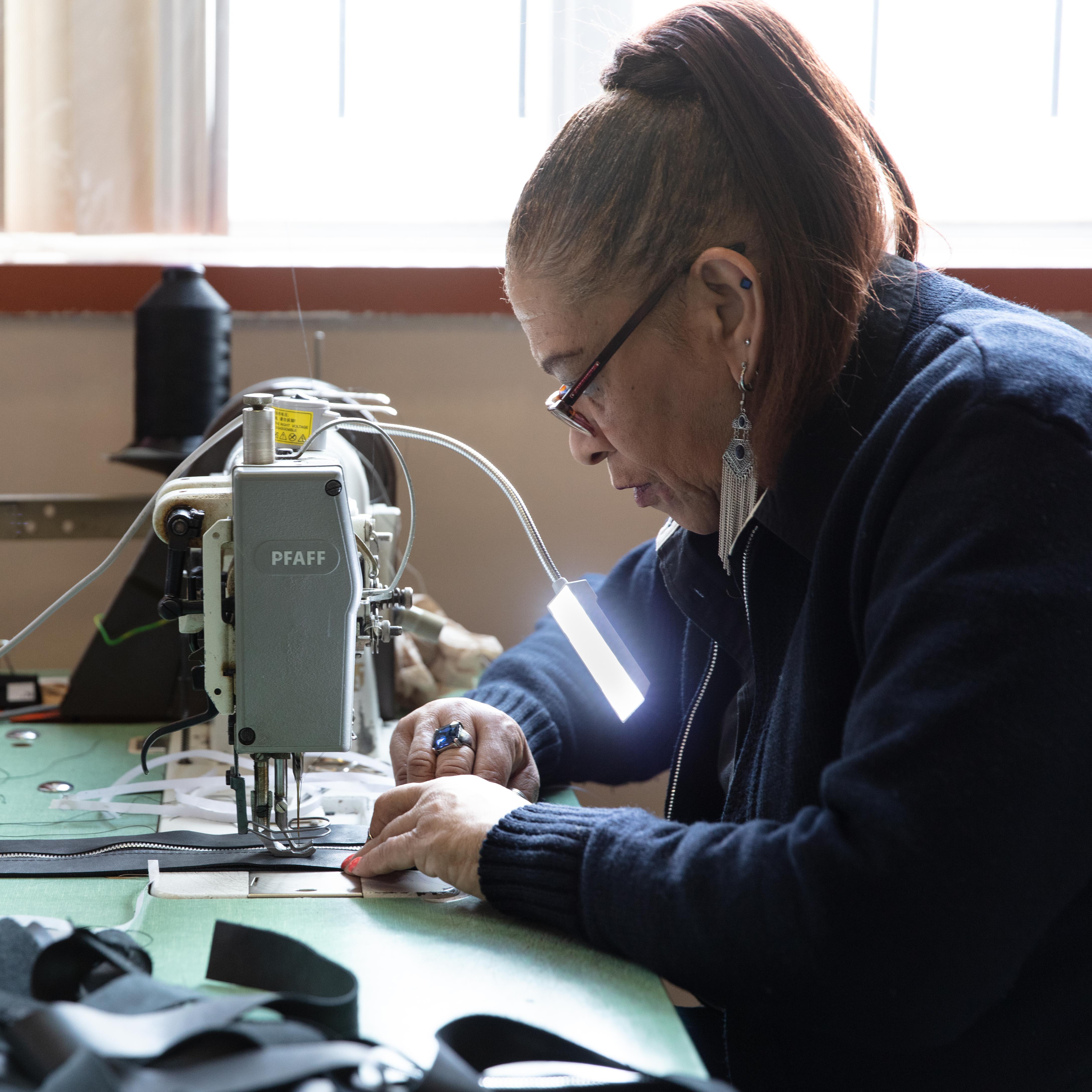 Detroiter and Spouse of a Veteran sewing the tote in Detroit.