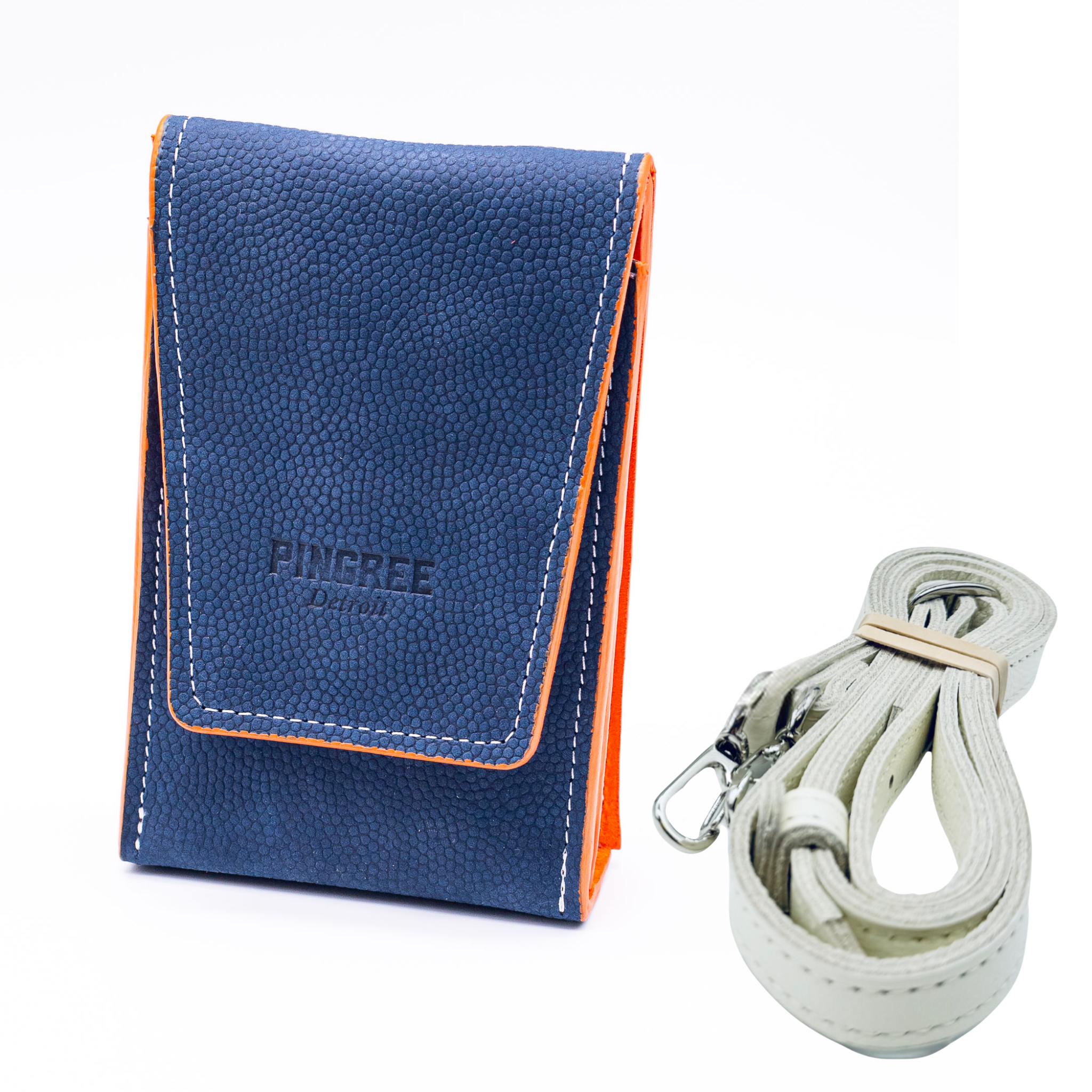 Navy blue pebbled leather on the exterior with orange on the inside and edges. A stadium bag that can be worn on a belt or as a crossbody. Carries your phone and features magnetic closure.  With leather strap on a white background. Made in Detroit with leather upcycled from the automotive industry with the Pingree logo on the front and silver hardware made in America. 