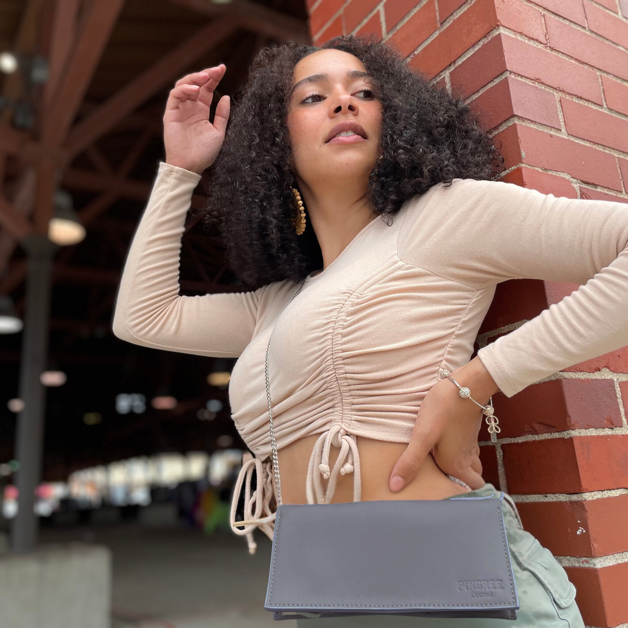 Detroit made 5-in-1 bag . Pictured here in black leatrher. Works as a fanny pack, crossbody, shoulder bag, wristlet, clutch, or classic wallet. with usa made chain and auto leather sustainably upcycled and handmade in Detroit by Veterans and skilled makers.