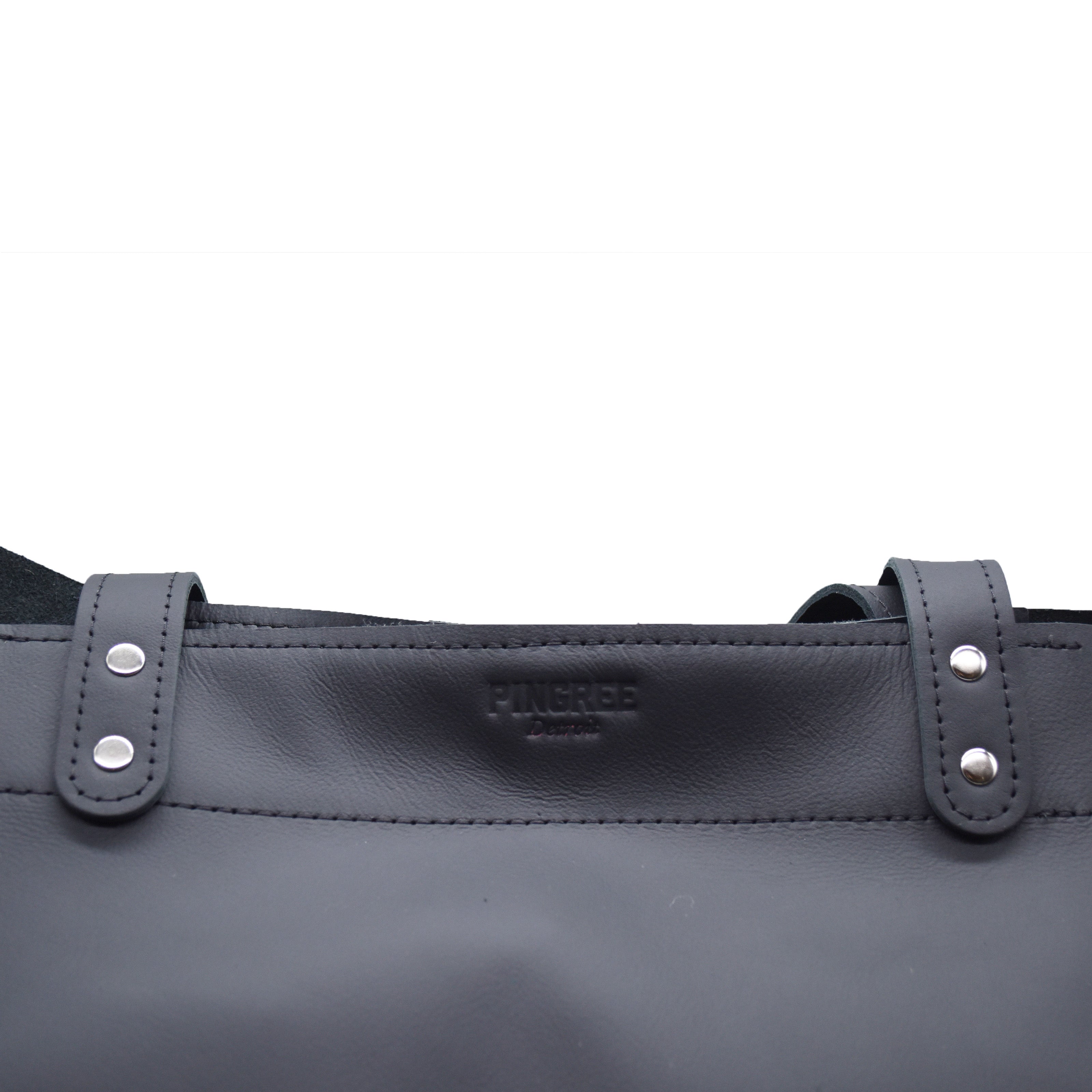 Close up of the logo on the 313 shopper bag made in Detroit. Tote bag Made by Pingree Detroit in the USA. Hardware American made. Stitching also military grade thread. Handmade by Veterans and Detroiters with new upscaled automotive leather. 