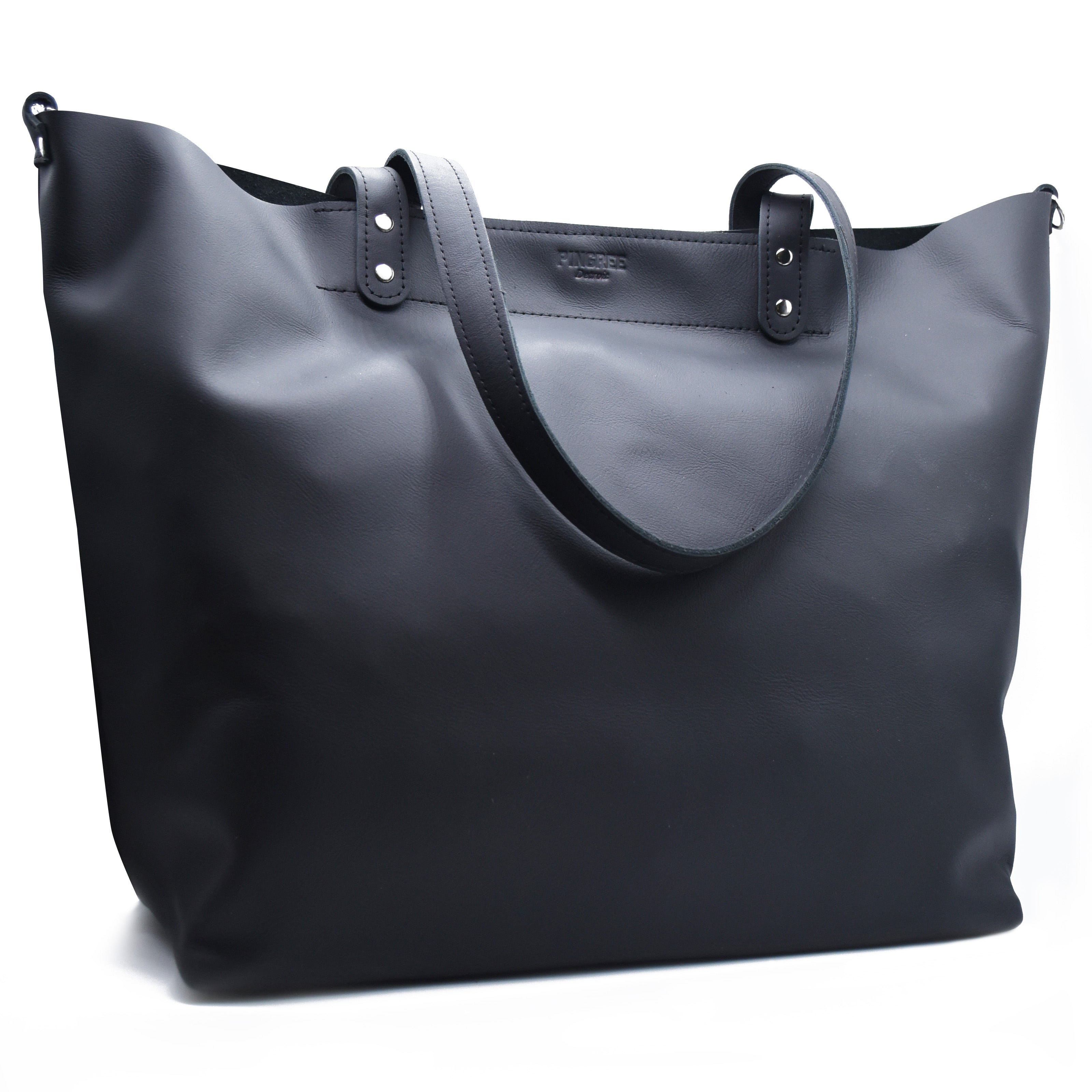 Close up of the logo on the 313 shopper bag made in Detroit. Tote bag Made by Pingree Detroit in the USA. Hardware American made. Stitching also military grade thread. Handmade by Veterans and Detroiters with new upscaled automotive leather. 