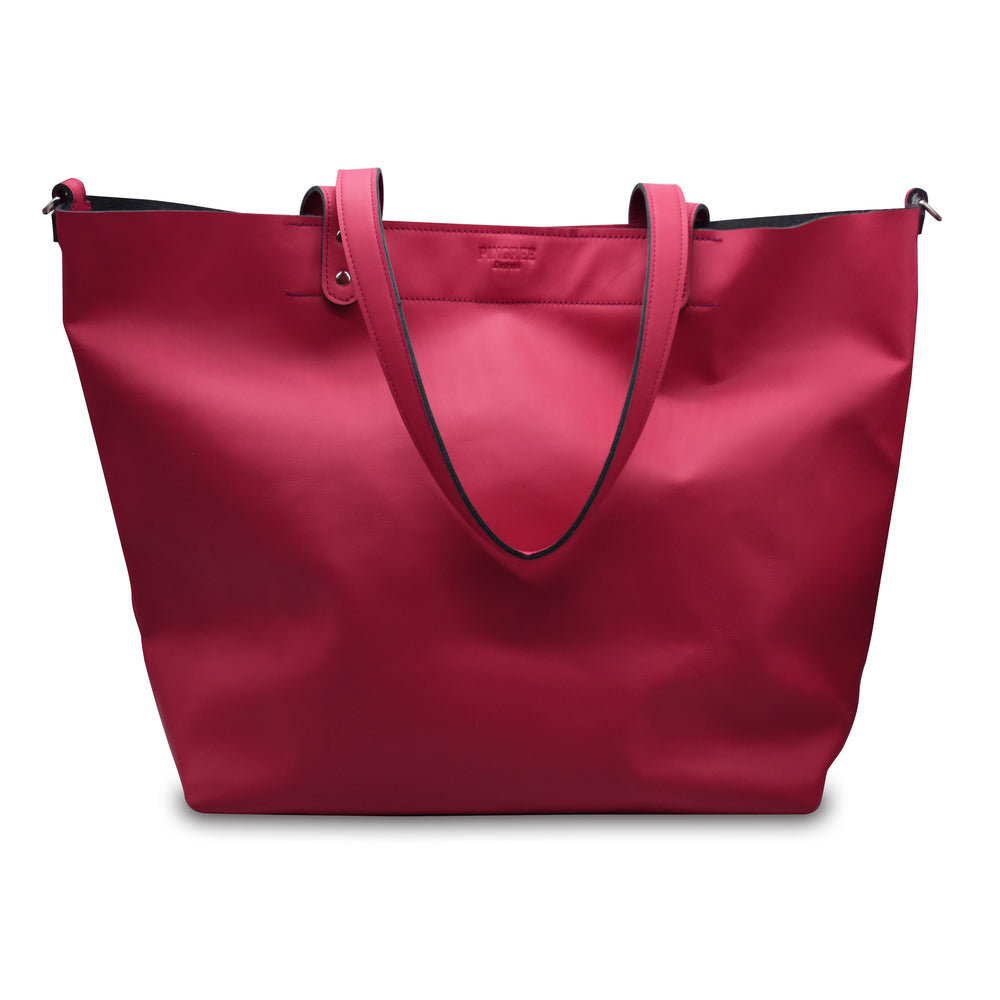 Hot pink shopper tote bag with black accents on a white background. Made in Detroit. Leather bag crafted from upcycled automotive leather. Crossbody strap available. 