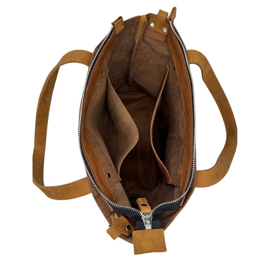 Open view inside the bag. Two large pockets visible.M1 Leather Work & Travel zipper Tote in brown leather with seat belt strap upcycled and sustainably made in Detroit