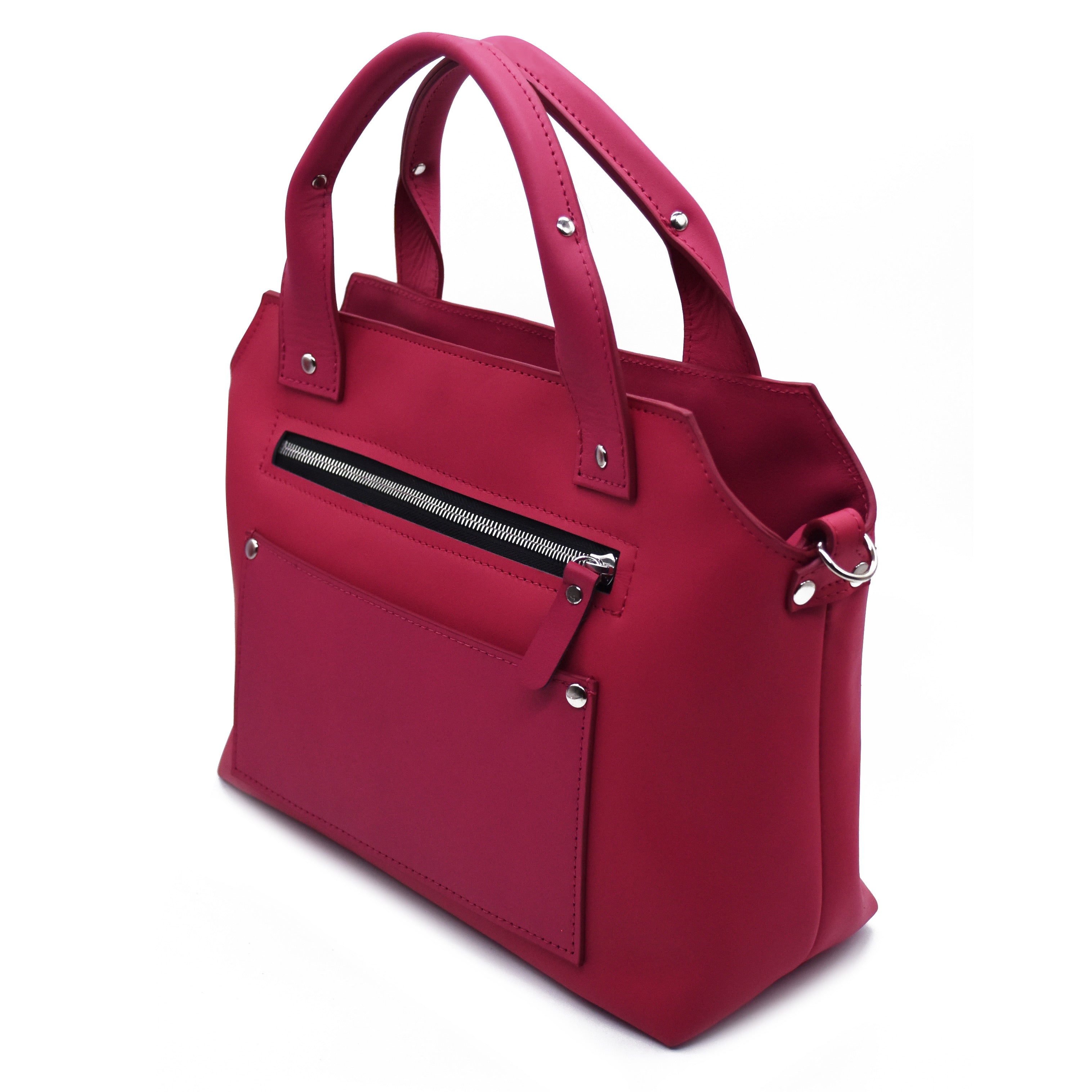 Pink purse. Handles upward. Silver rivets and silver hardware. Boston bag style with Detroit flair. Exterior zipper shown and exterior slip pocket in image with cross-body strap d-ring shown. 