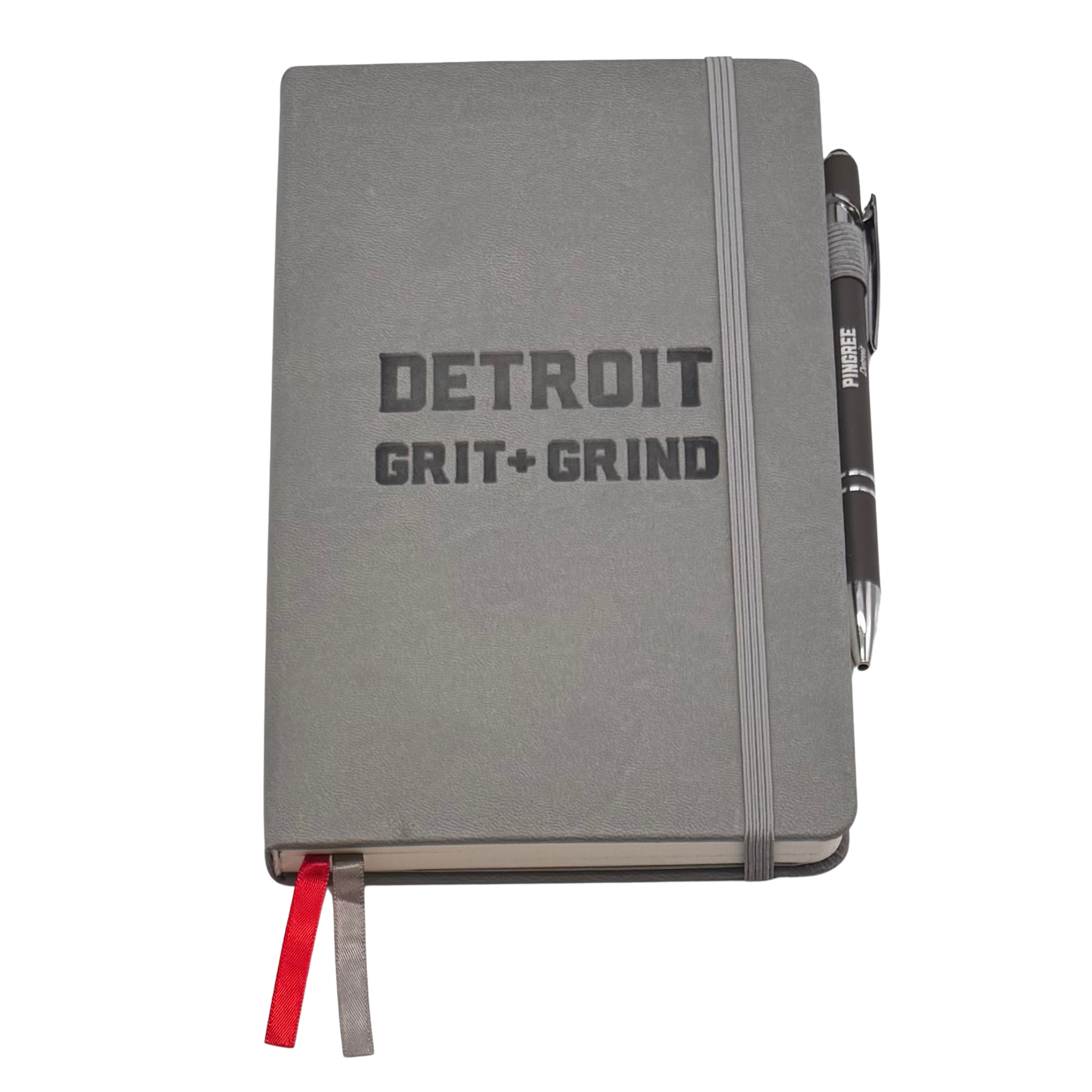 Gray notebook with 'Detroit Grit Grind' text and a pen on a white background. Our hand assembled Journal crafted with 100% recycled paper pulp with lined pages. Detroit made me. Includes a pen, double bookmarks a front pocket and a rear pocket and elastic closure that we sew for reinforcement. A 5 size, comparable to a moleskine style, fits inside of our portfolio or works great as a standalone.