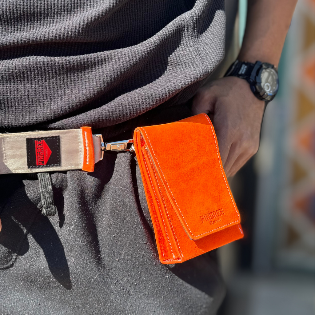 Fanny pack profile. The Motown venue bag, a pouch sized to get into any sports, stadium, concert venue, and performance hall. Pictured here in Tiger Lily orange with seat belt strap option. 4” x 6” x 1.5” Handmade by Veterans and DETROITERS with Upcycled leather from the auto industry. Available with a leather strap or a seatbelt strap.
