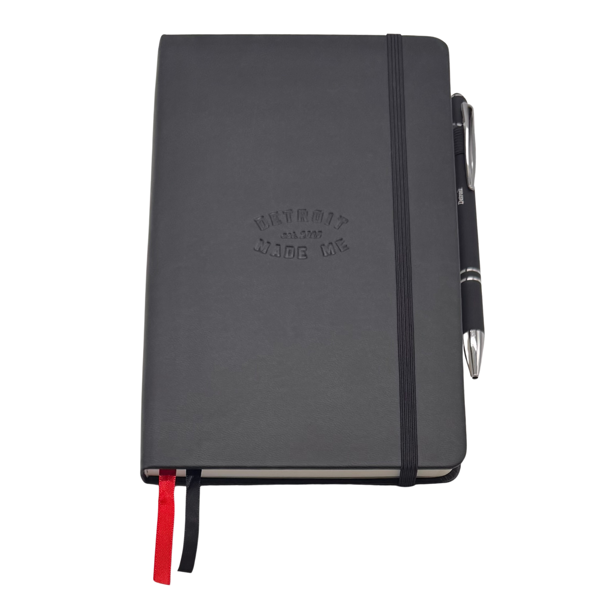 Black notebook with a pen on a white background. Our hand assembled Journal crafted with 100% recycled paper pulp with lined pages. Detroit made me. Includes a pen, double bookmarks a front pocket and a rear pocket and elastic closure that we sew for reinforcement. A 5 size, comparable to a moleskine style, fits inside of our portfolio or works great as a standalone.