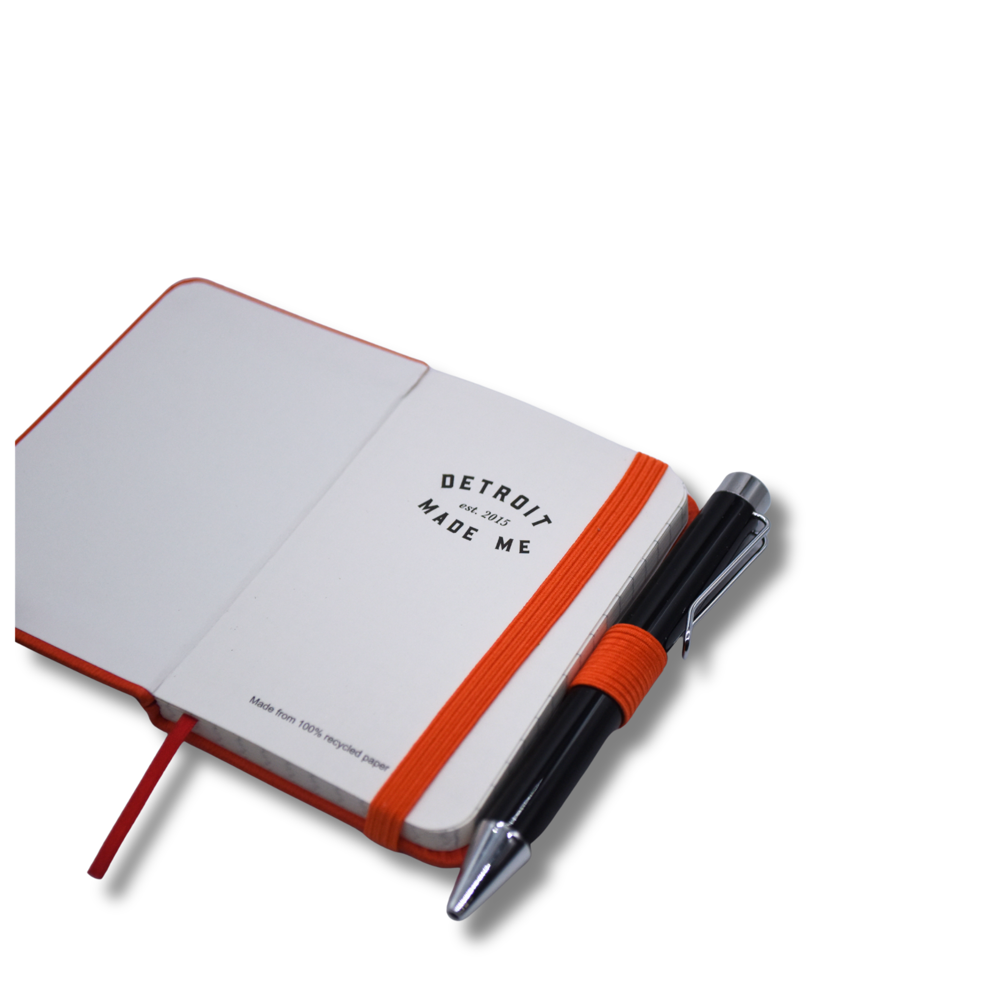 Open notebook with orange band and pen on a white background. Pocket journal. Pocket notebook. 