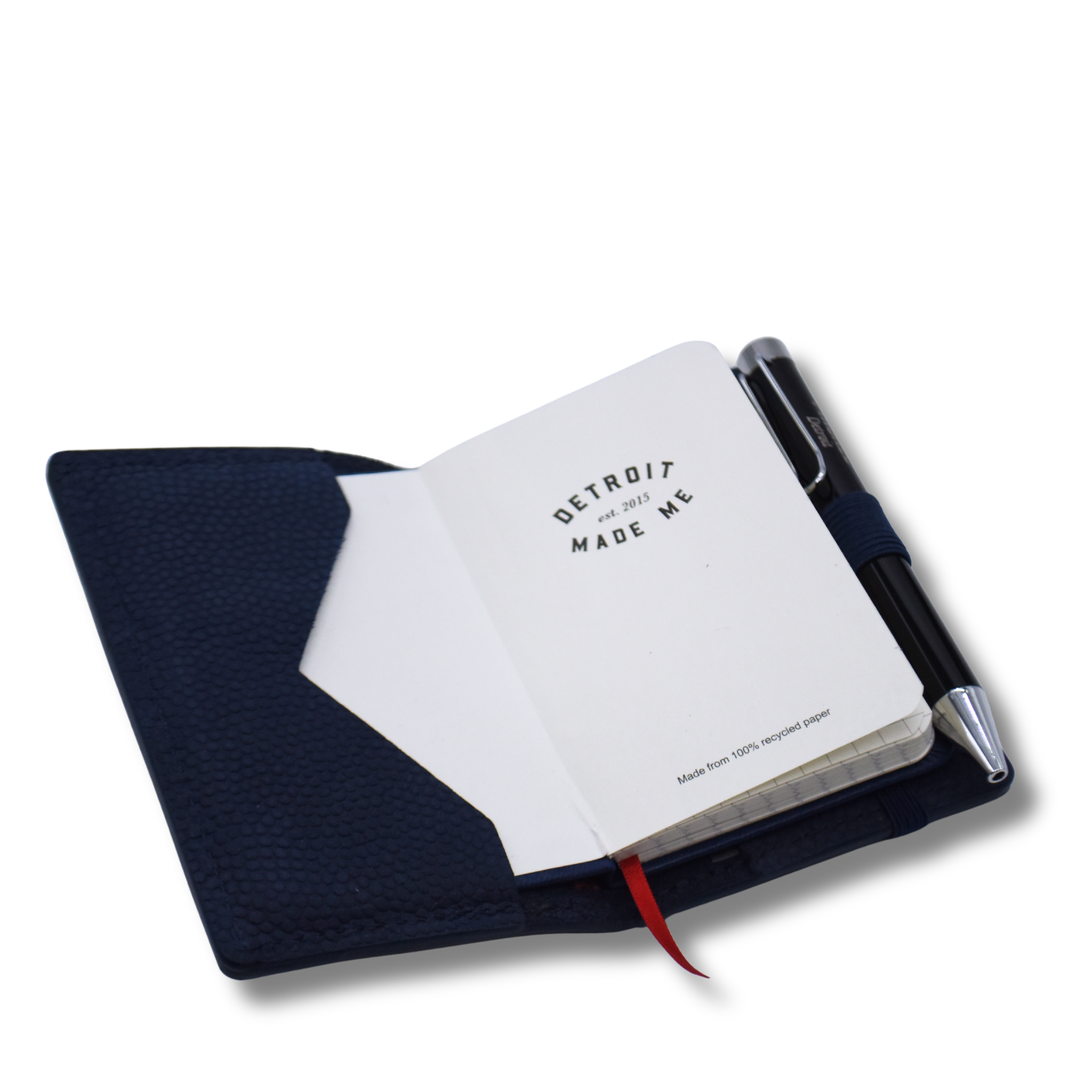 Open notebook with pen on a white background. Fits nicely inside the Concord wallet. Sold separate. 
