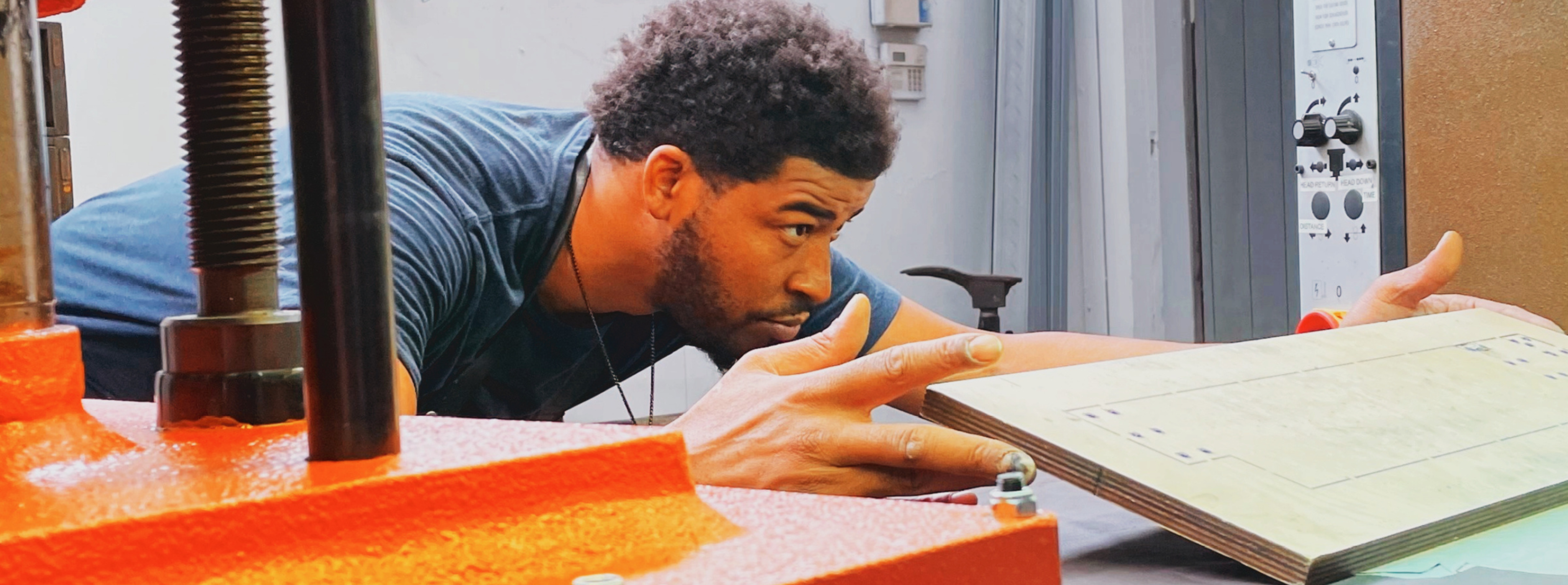 A veteran co-owner cutting leather goods in Detroit with upcycled automotive leather. 