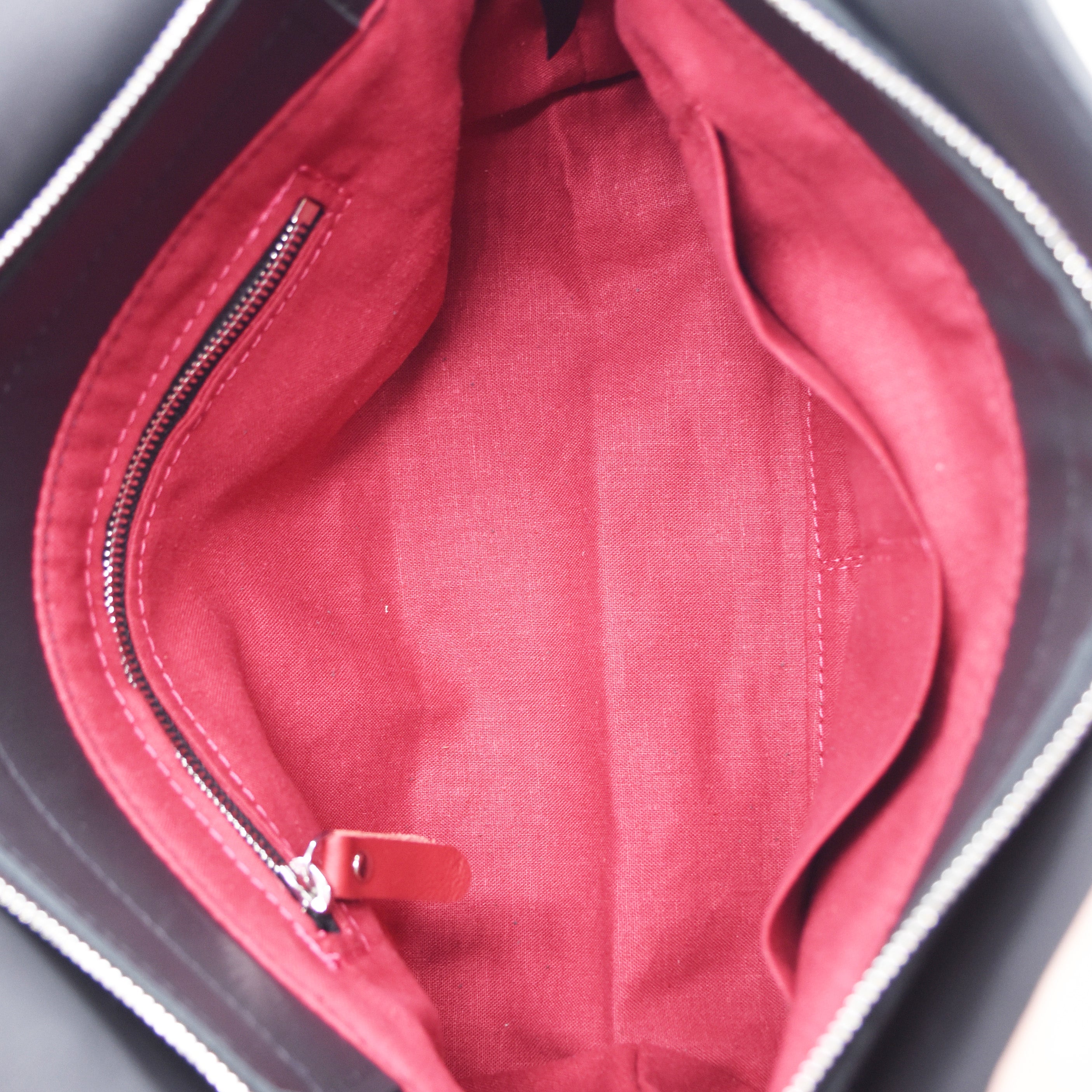 Black purse interior. Zipper and two slip pockets. 