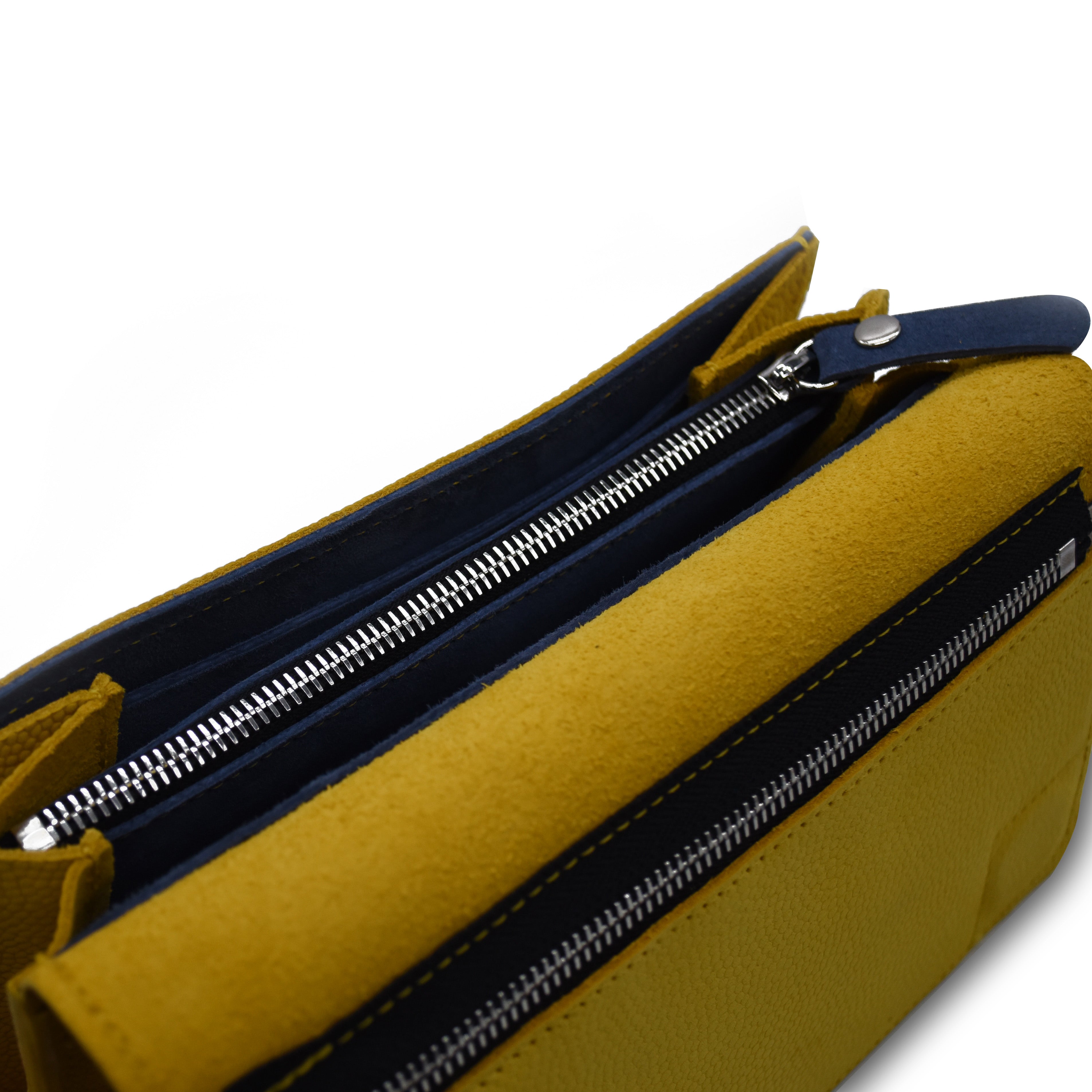 Yellow and blue leather bag with zippers on a white background