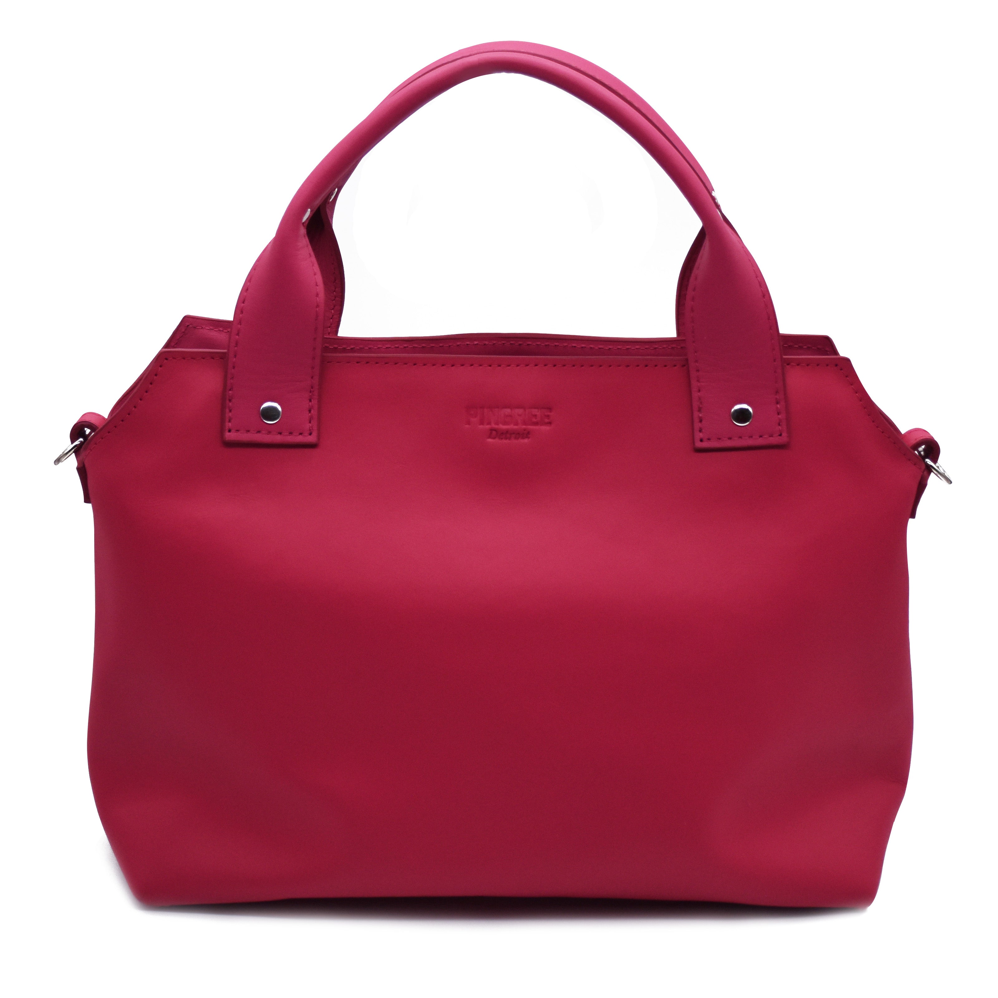 Pink purse. Handles upward. Silver rivets and silver hardware. Boston bag style with Detroit flair. Pingree logo top centered in image with cross-body strap d-ring shown. 