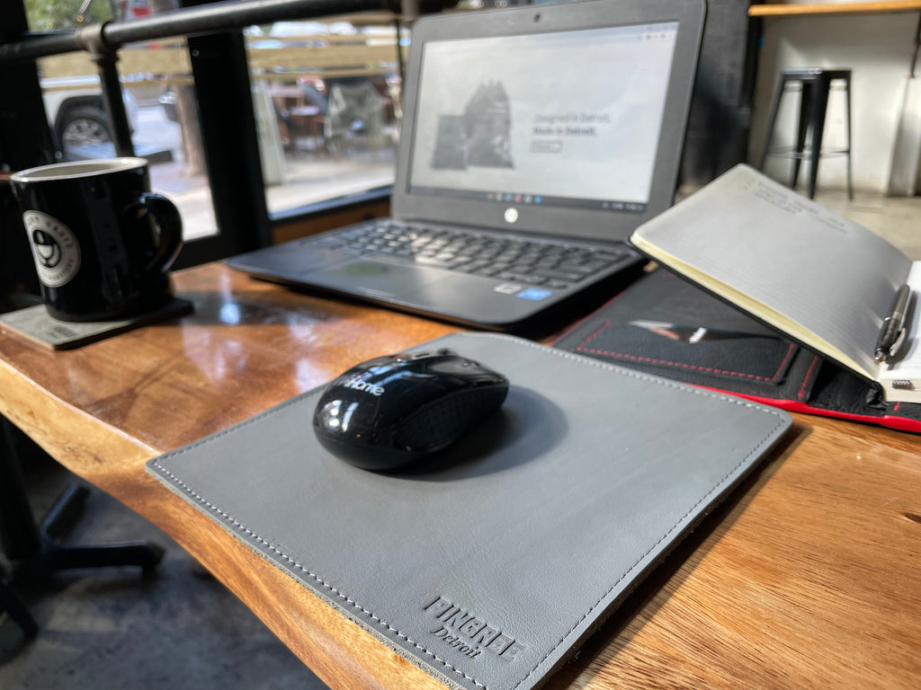 Motor City Mouse Pad at a coffee shop with a computer and work folio. All leather products made from materials diverted from the landfill.