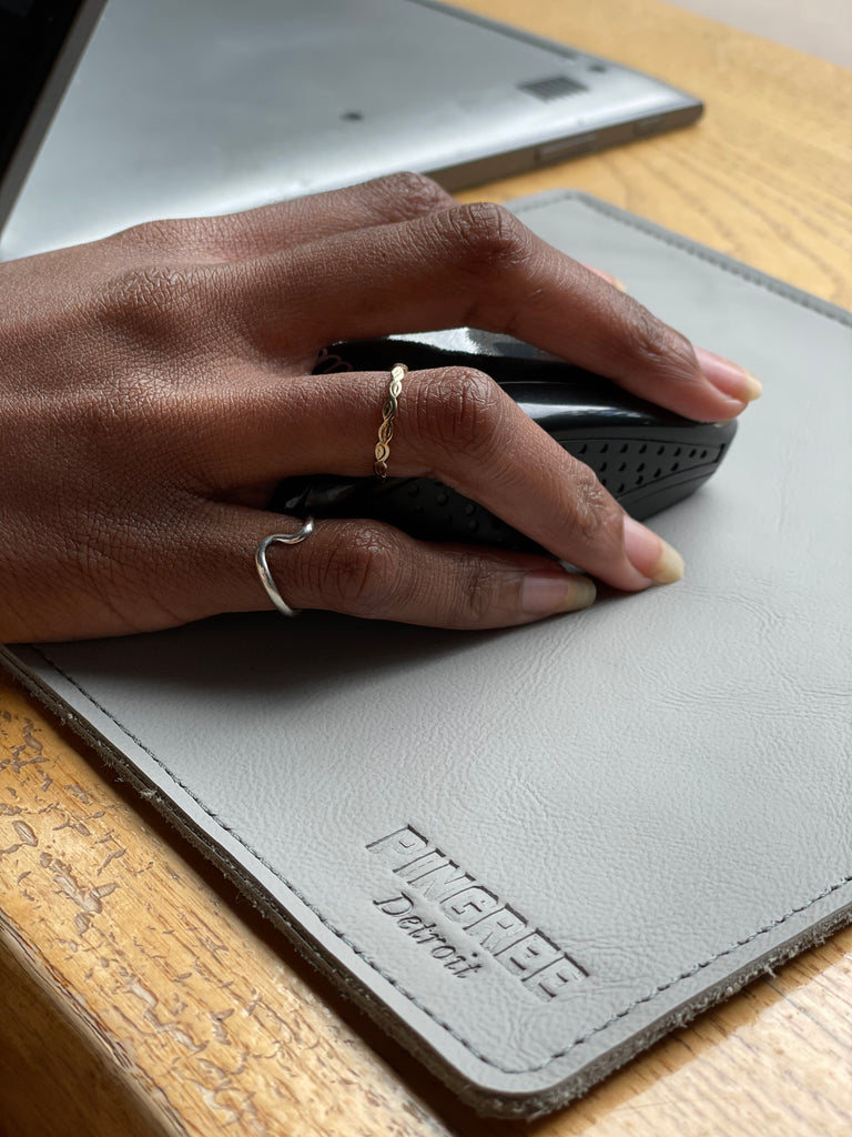 Pingree mouse pad in grey with mouse and hand on it. Handmade in the USA with automotive leather