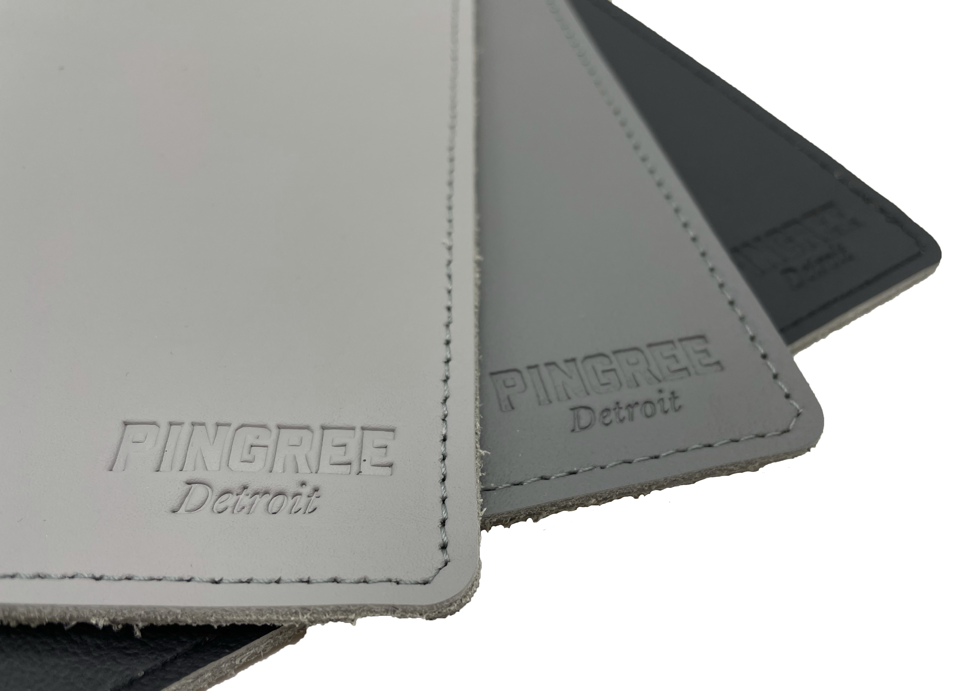 Pingree Mouse Pad in three shades of grey. Pingree logo prominently displayed on front corner of mouse pad. Made from repurposed automotive leather.